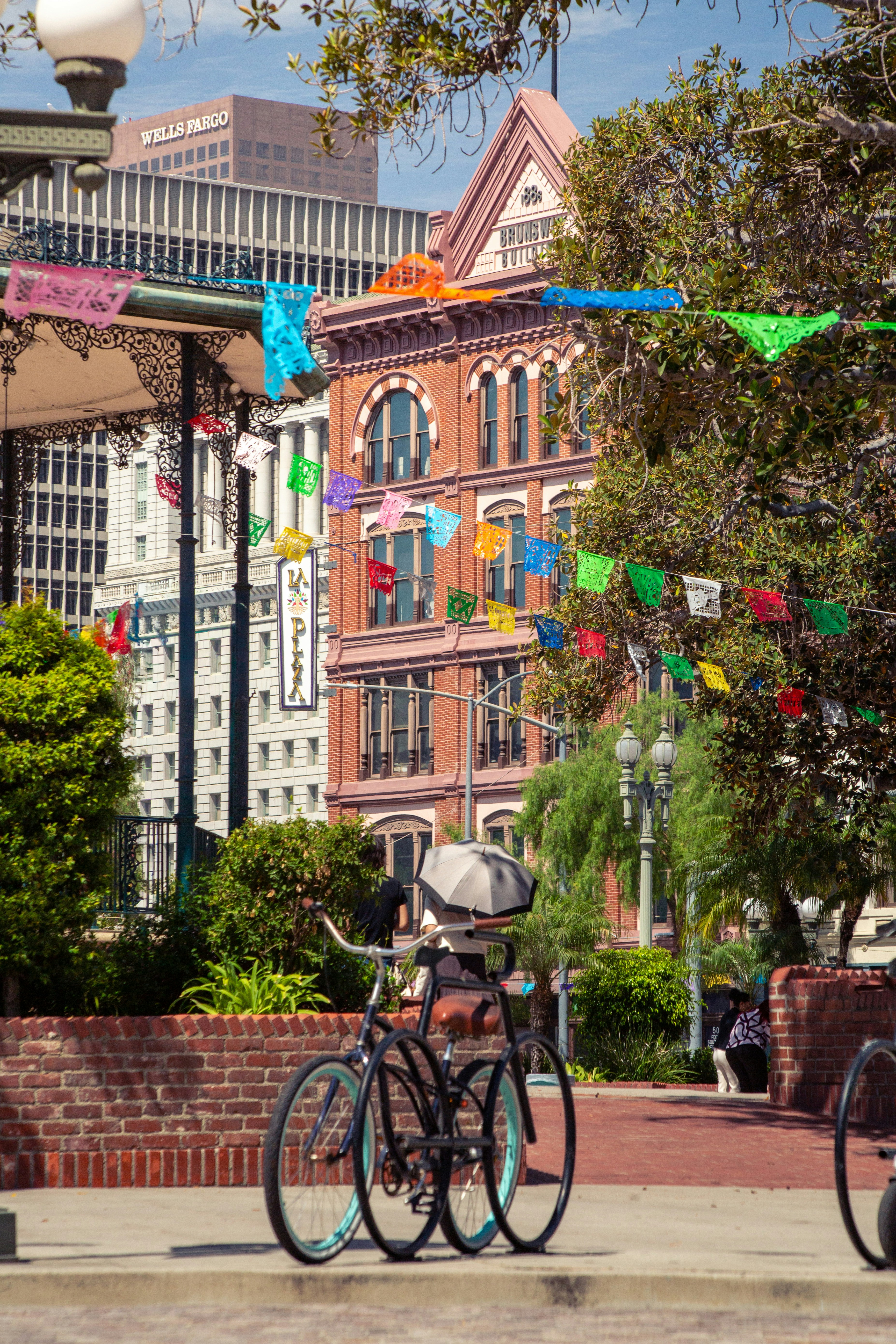 Historic brick building with colorful flags and a parked bicycle.