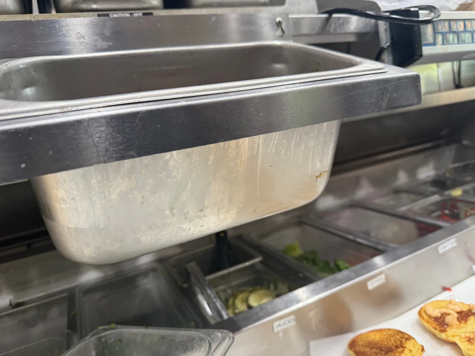 Stainless-steel food pan and work surface in a commercial kitchen
