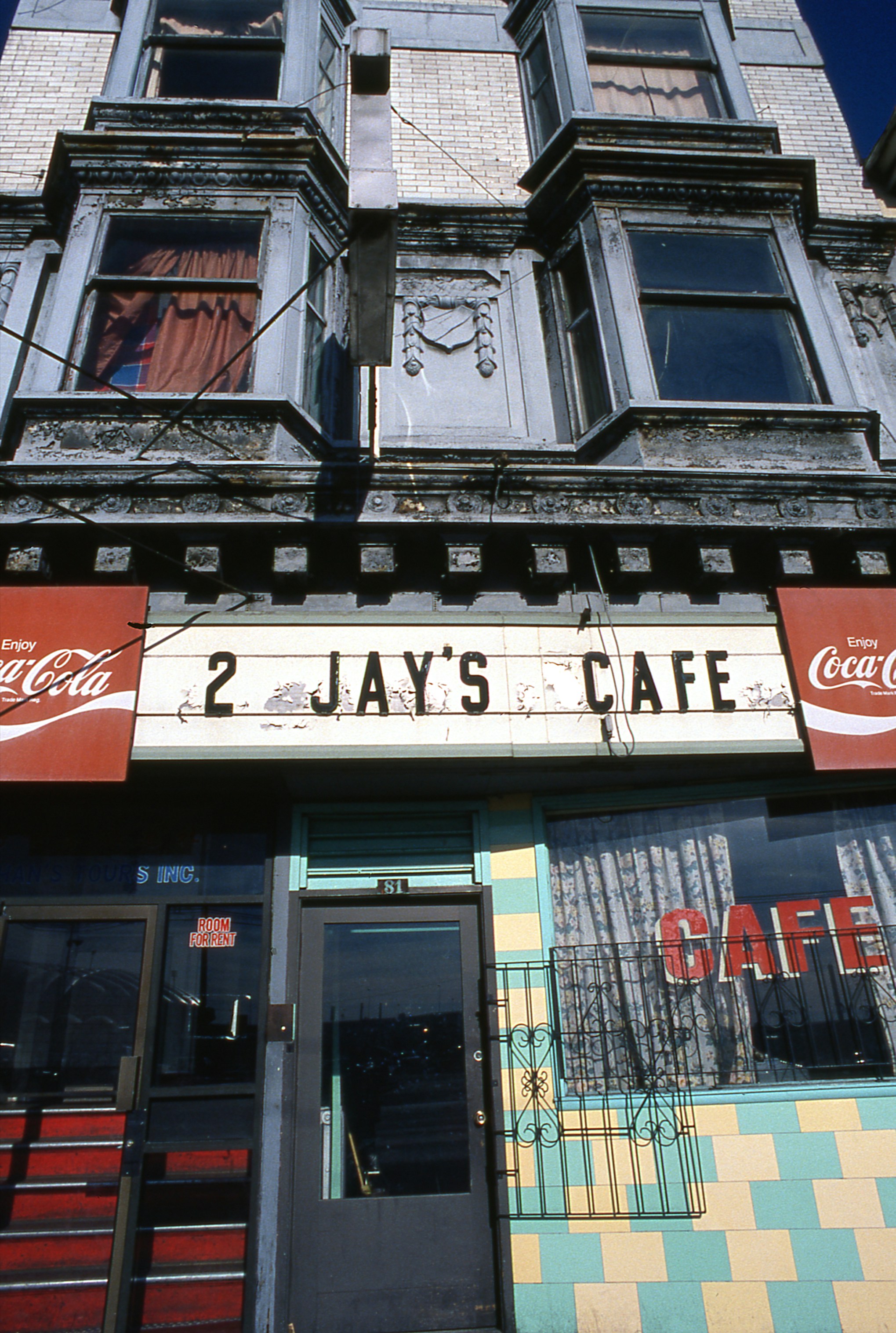 2 jay's cafe entrance with coca-cola signs and building above
