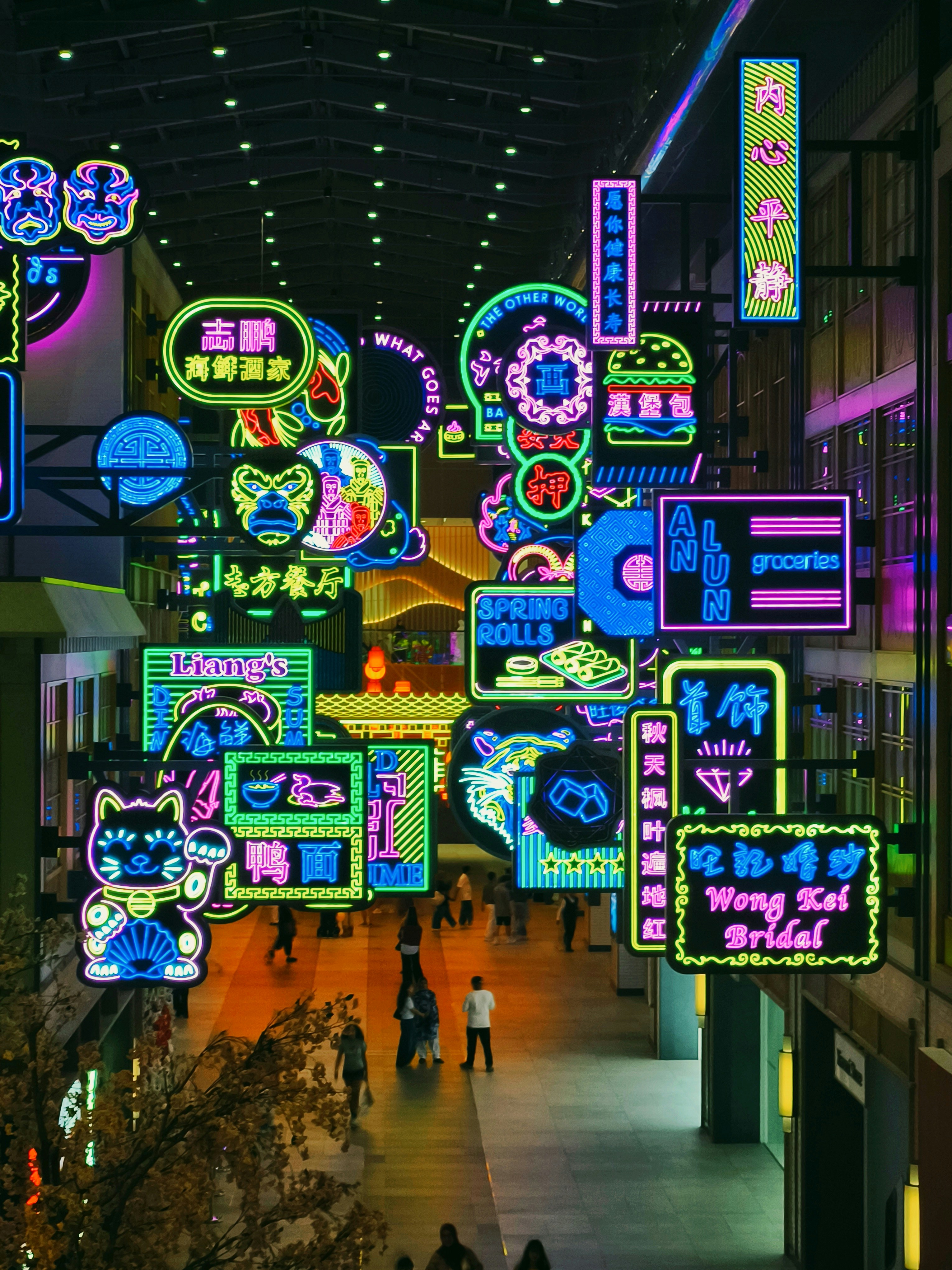 Vibrant neon signs illuminate a bustling street at night
