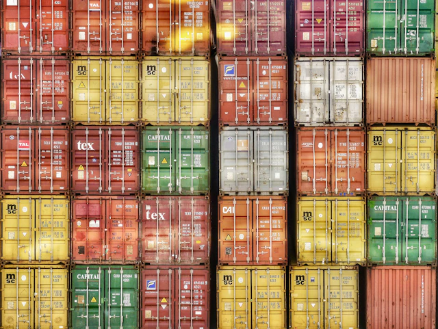 A wall of stacked shipping containers