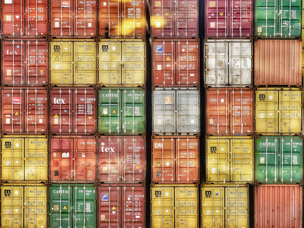 A wall of stacked colorful shipping containers