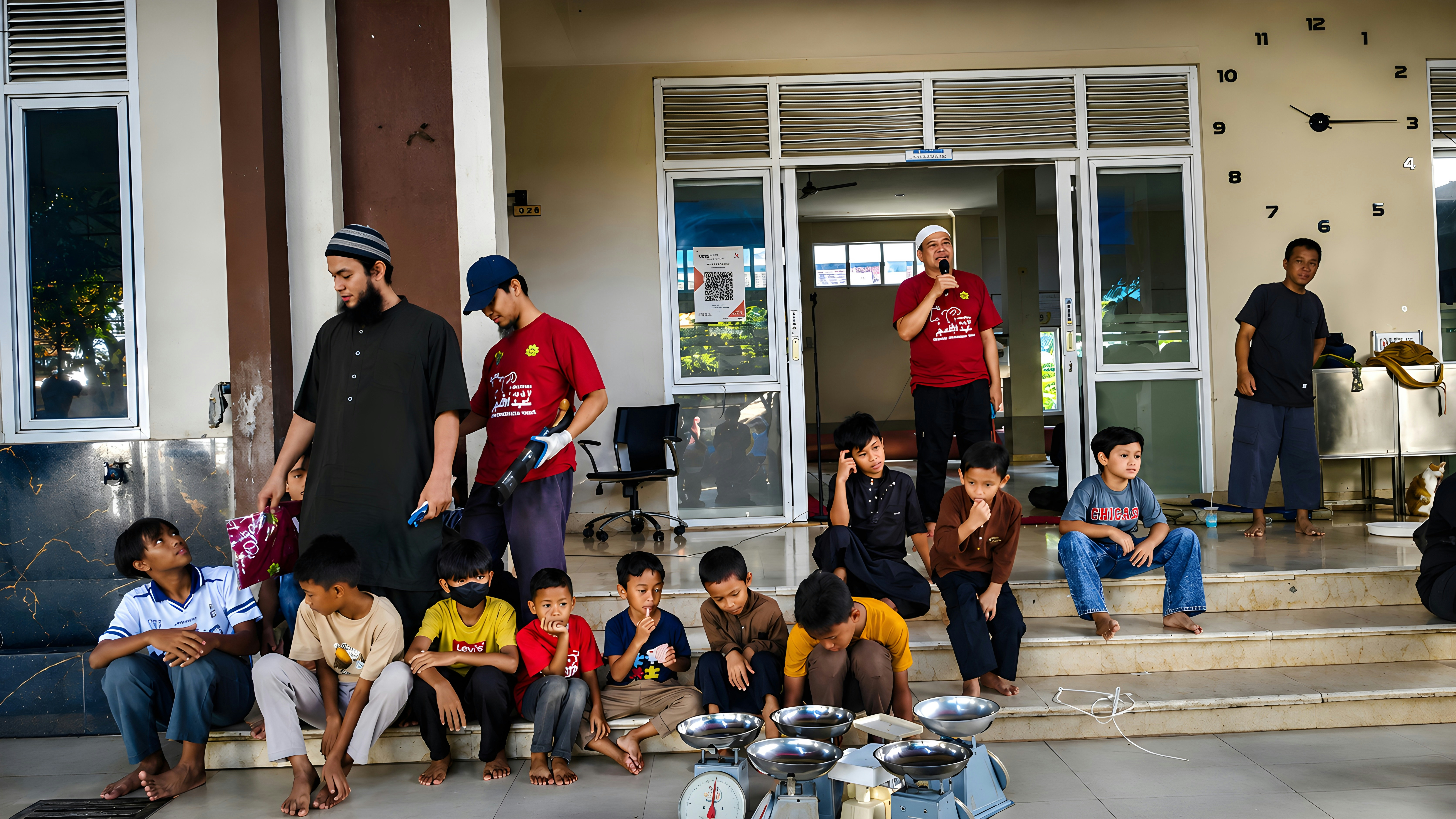 Men distributing food to children sitting on steps outdoors