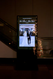 A glowing digital display shows a wedding couple