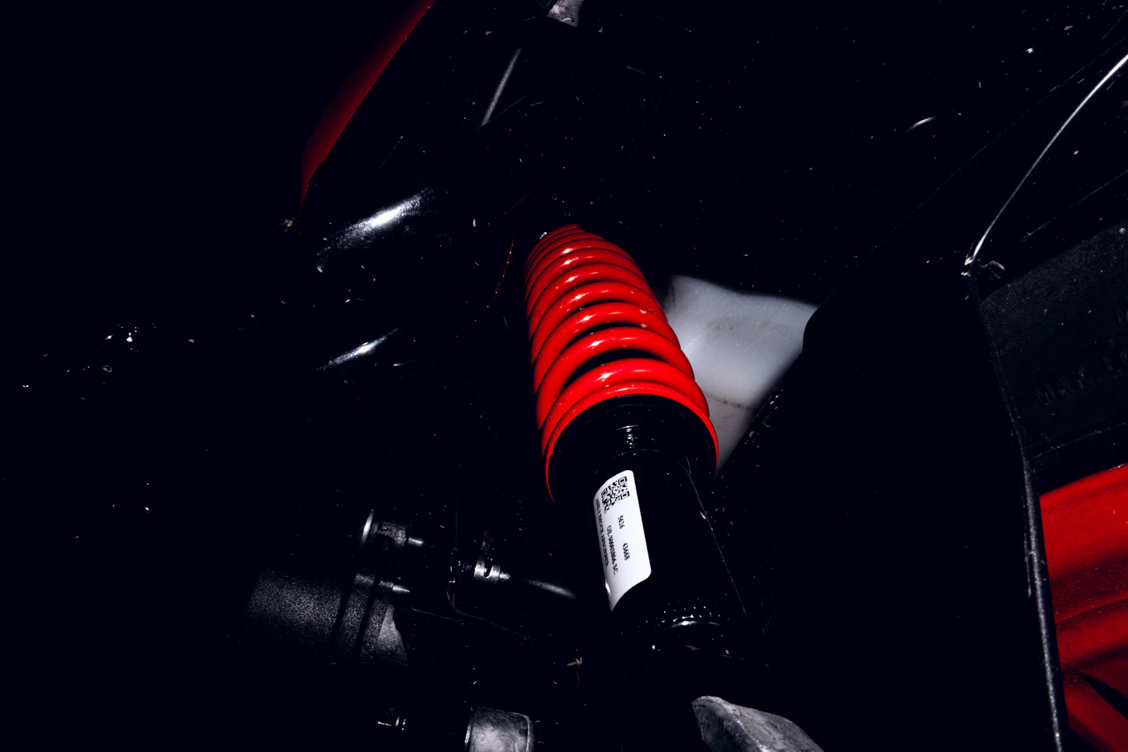 A red coil spring and shock absorber