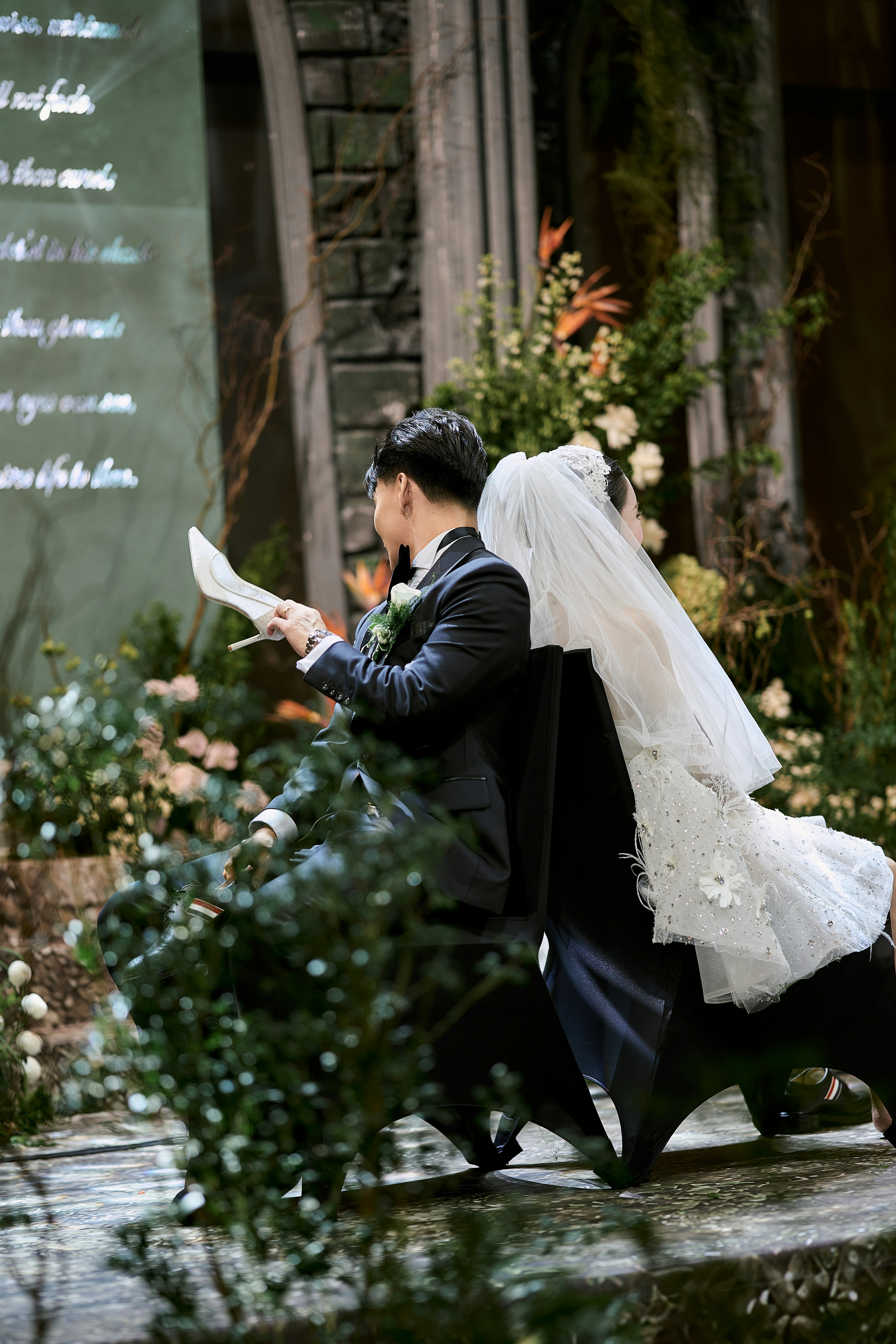 Bride and groom playing a wedding game with shoes