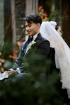 Smiling groom in tuxedo at wedding ceremony.