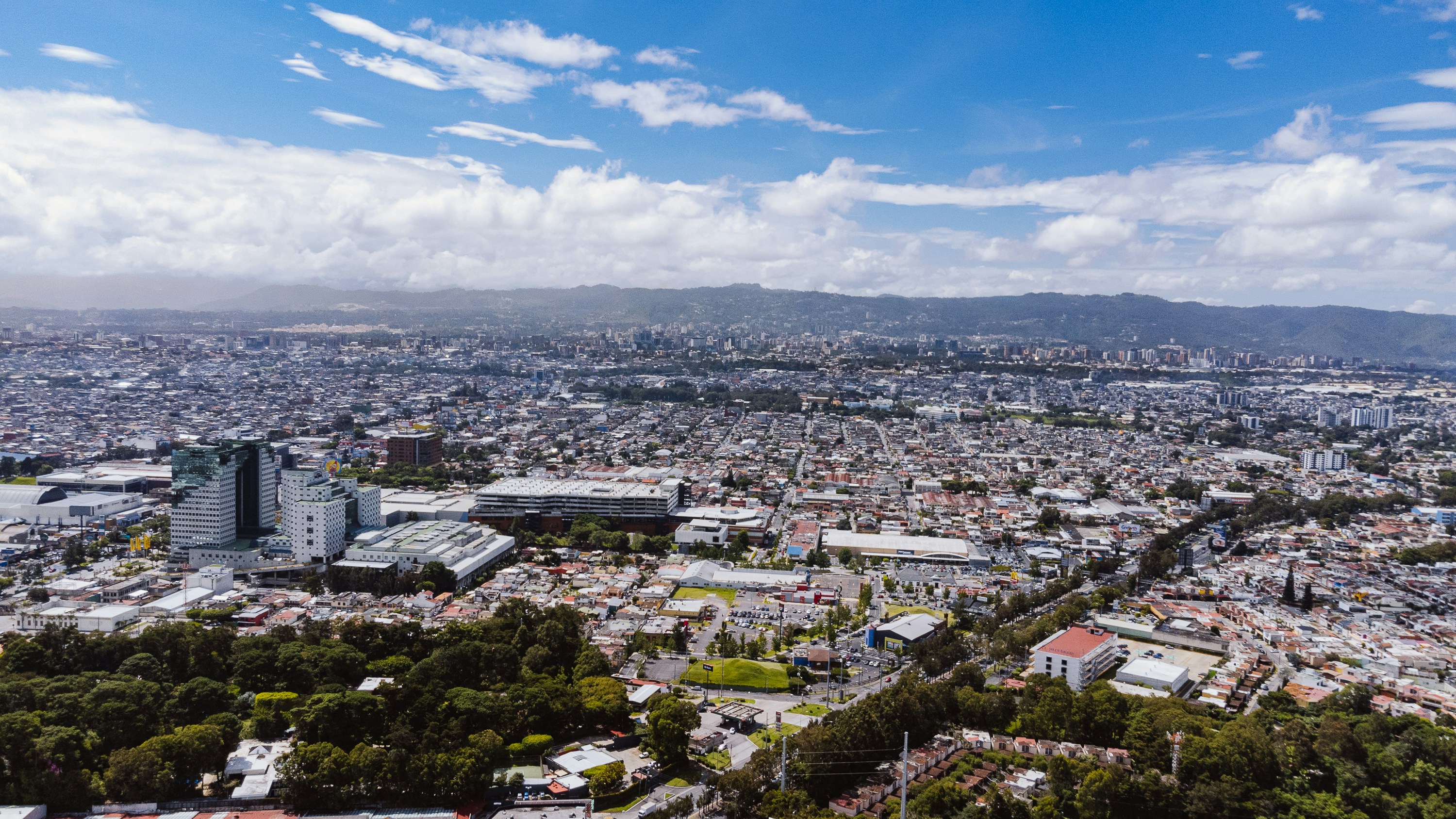 Aerial view of a sprawling city under a cloudy sky.