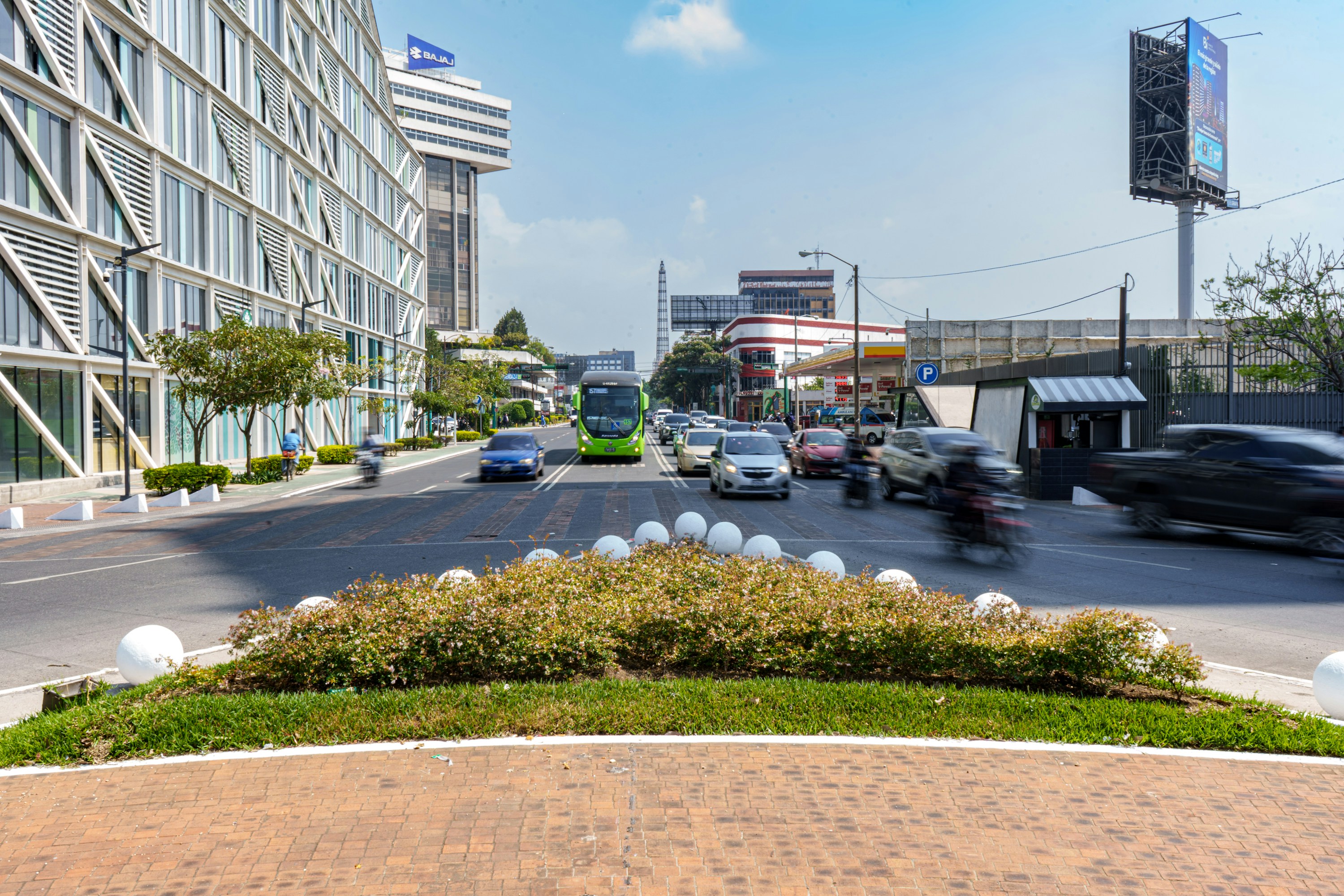 Busy city street with modern buildings and moving traffic