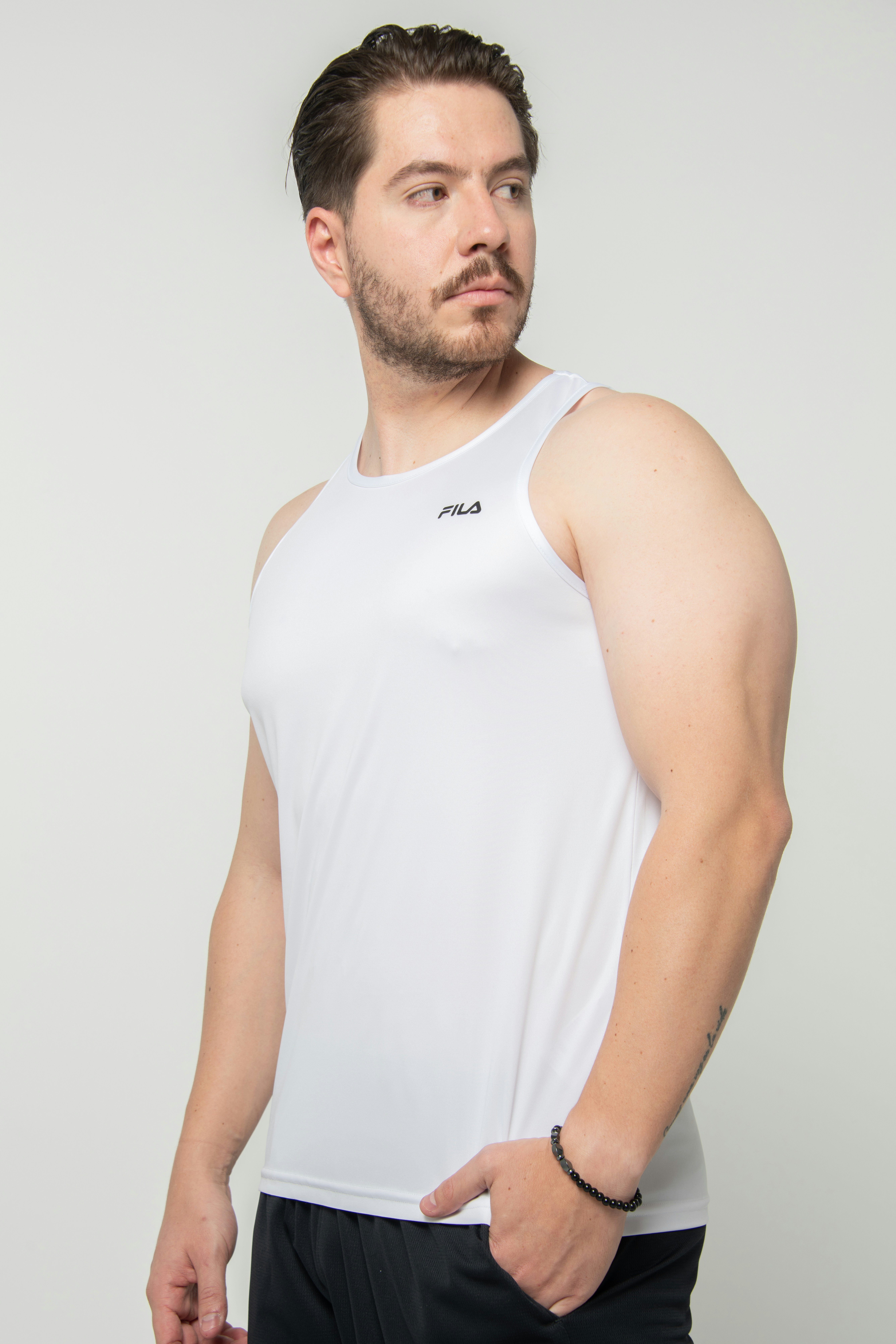 Young man wearing a white fila tank top