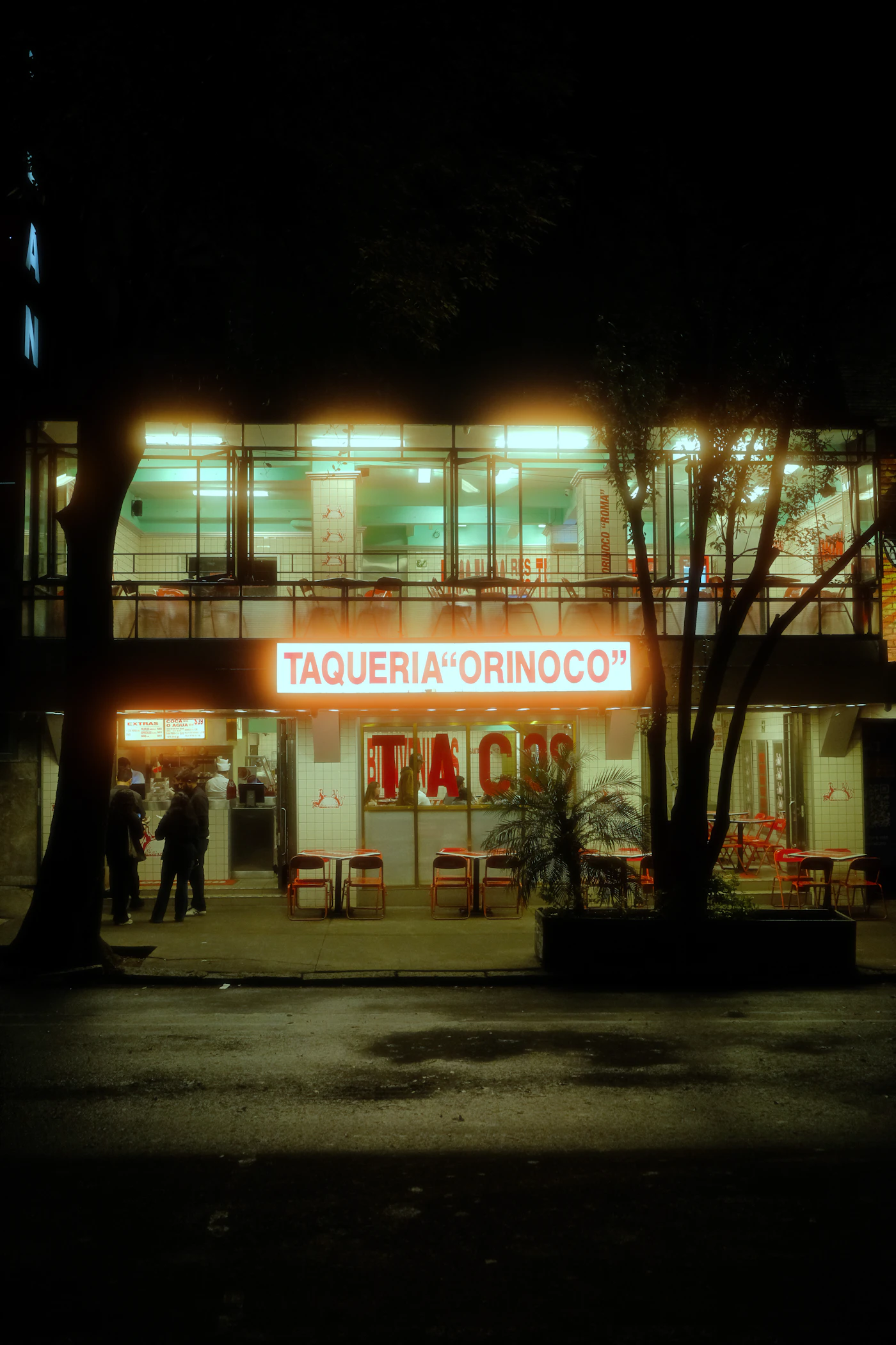 The taqueria lit up at night