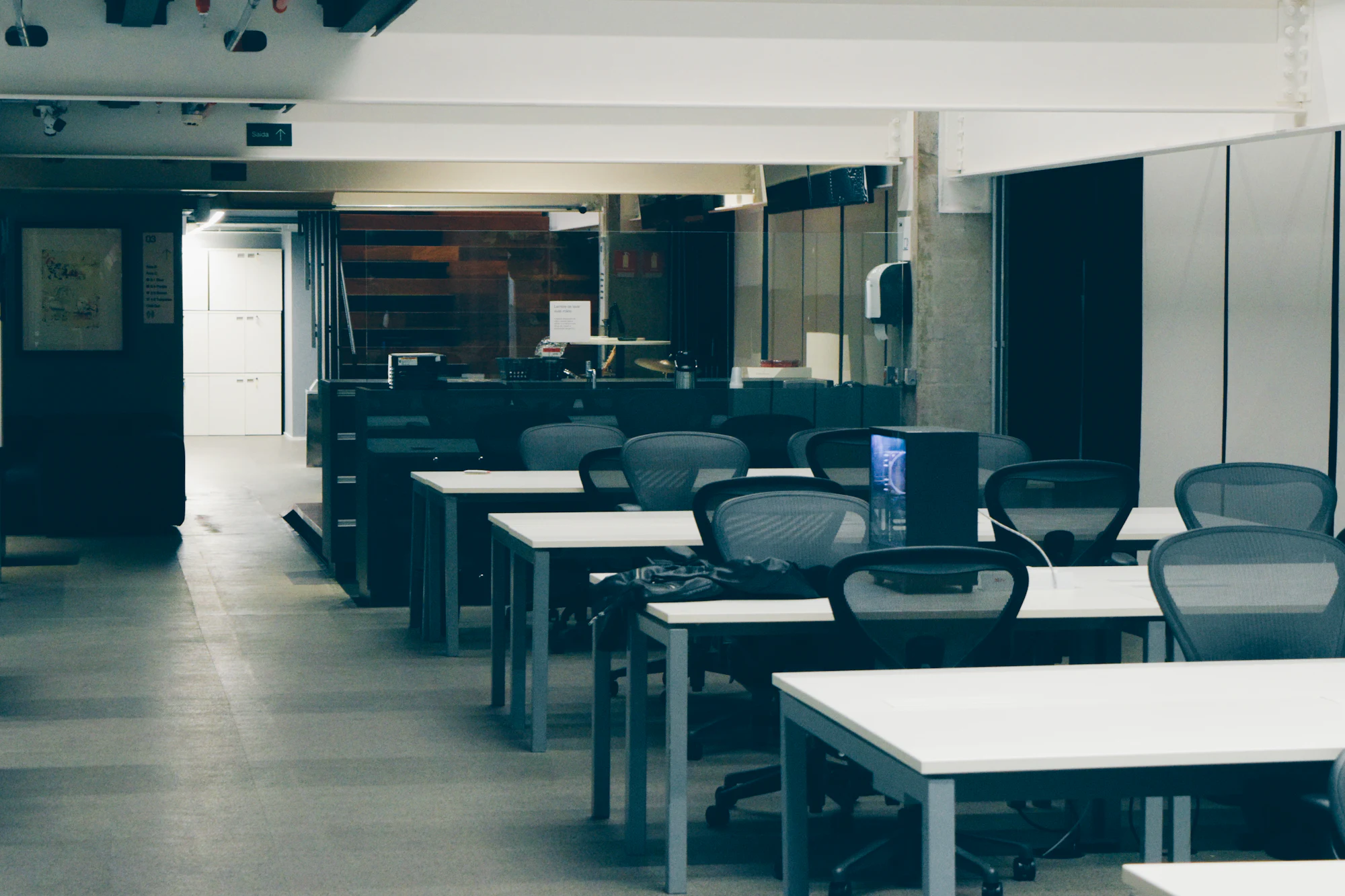 An empty modern office with rows of desks, cleared for relocation