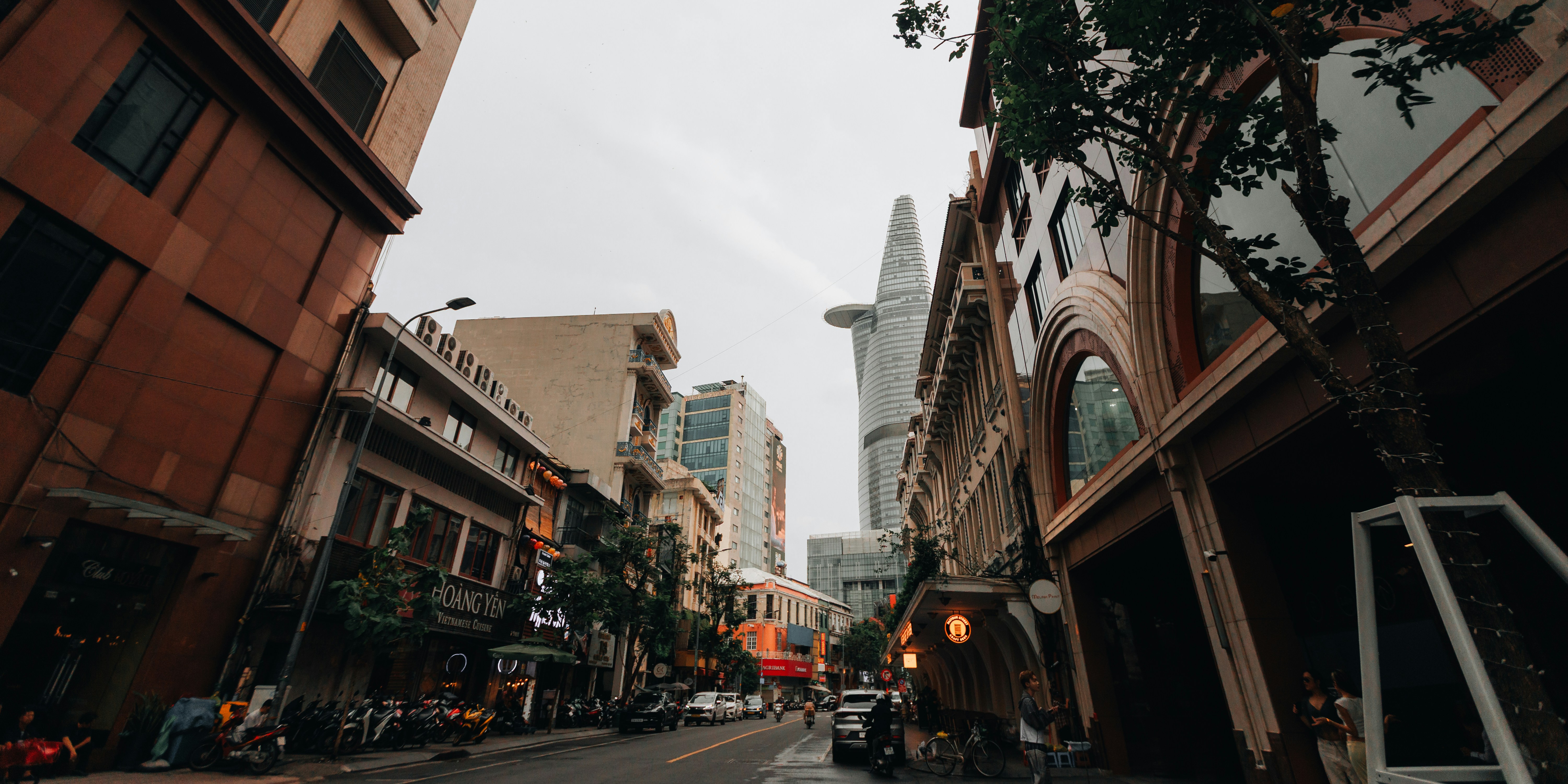 Urban street scene with historic buildings and modern skyscraper