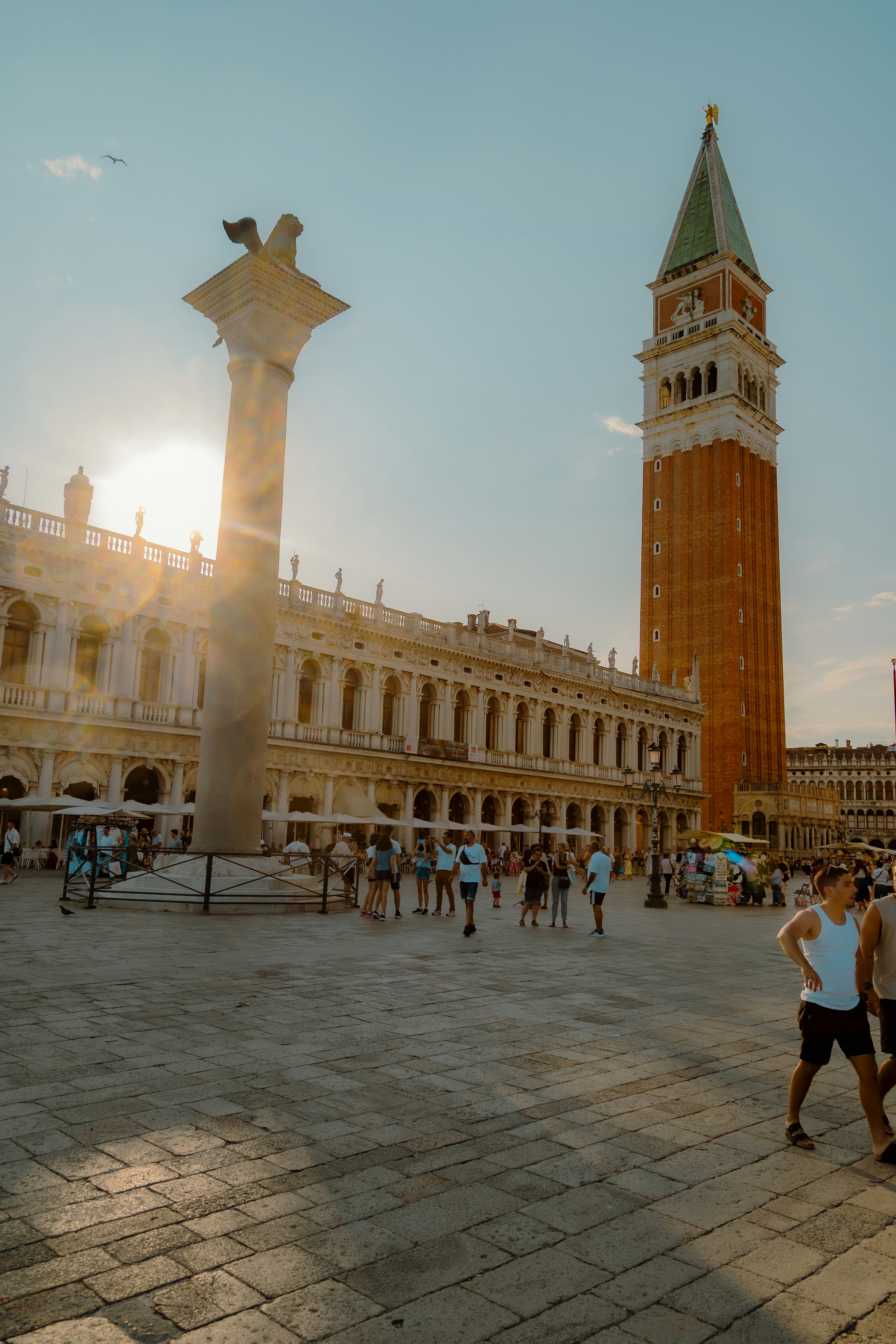 St. mark's square in venice with campanile and sun flare.