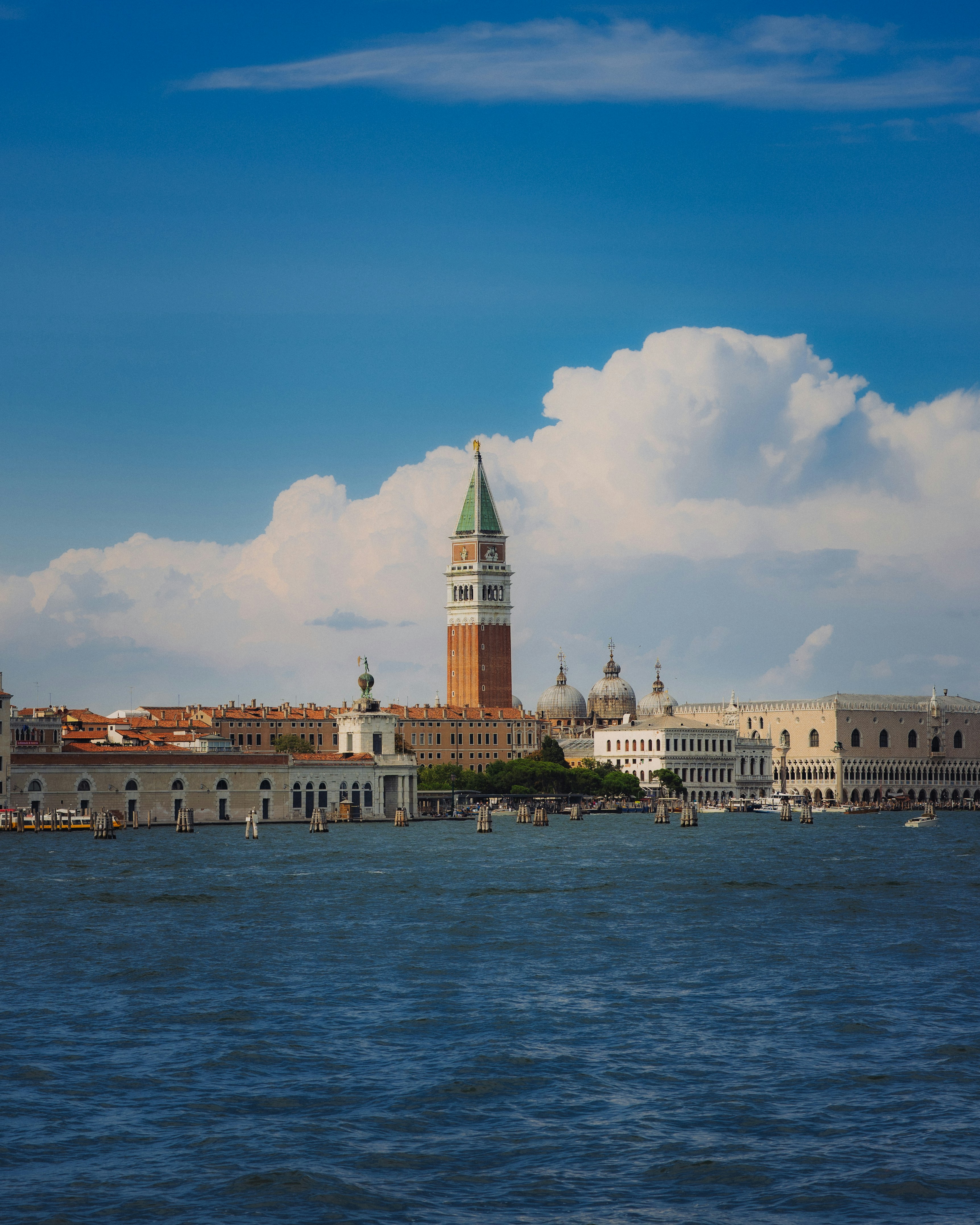 Historic venice buildings and bell tower across the water.