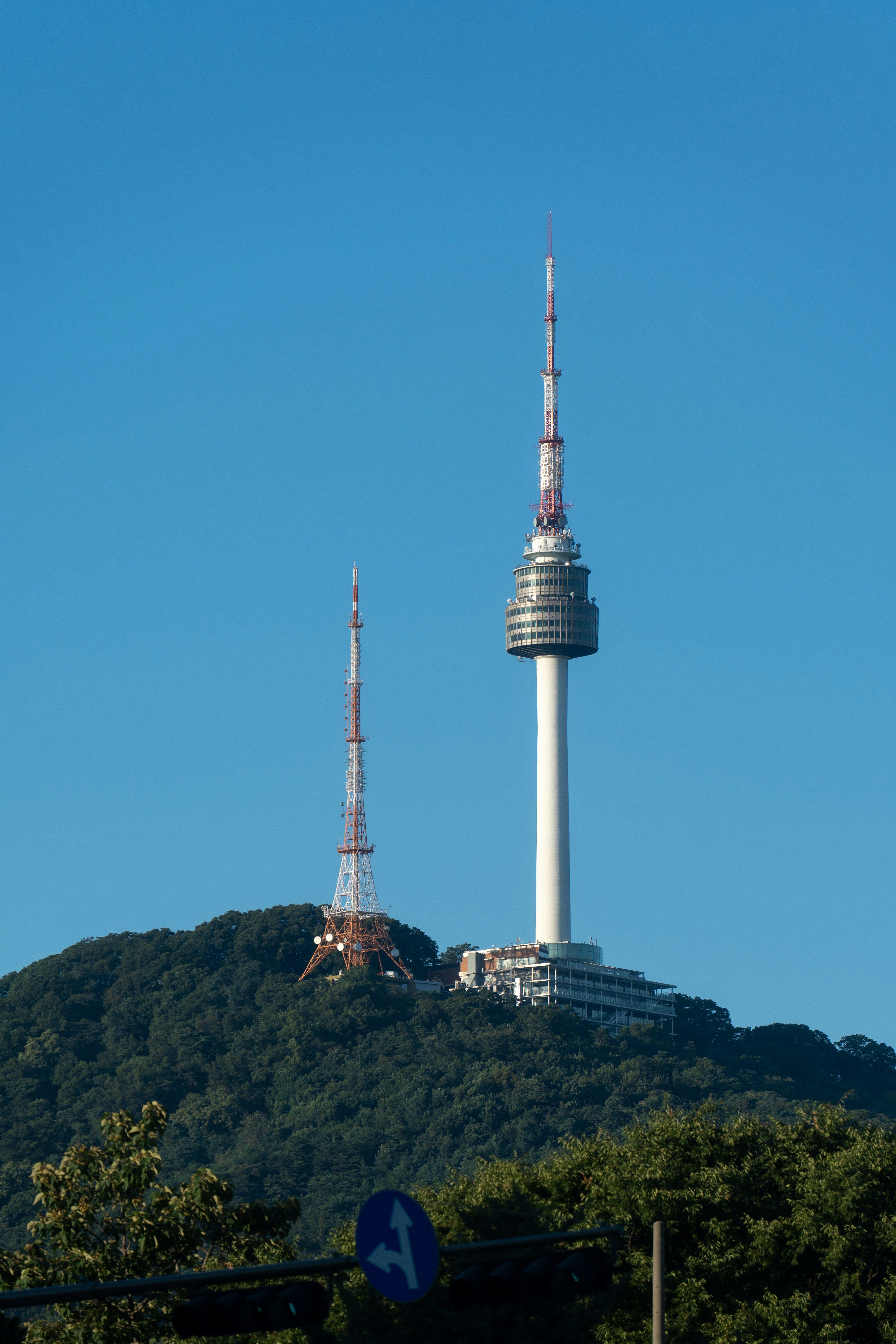 N seoul tower and communication tower on a green hill.