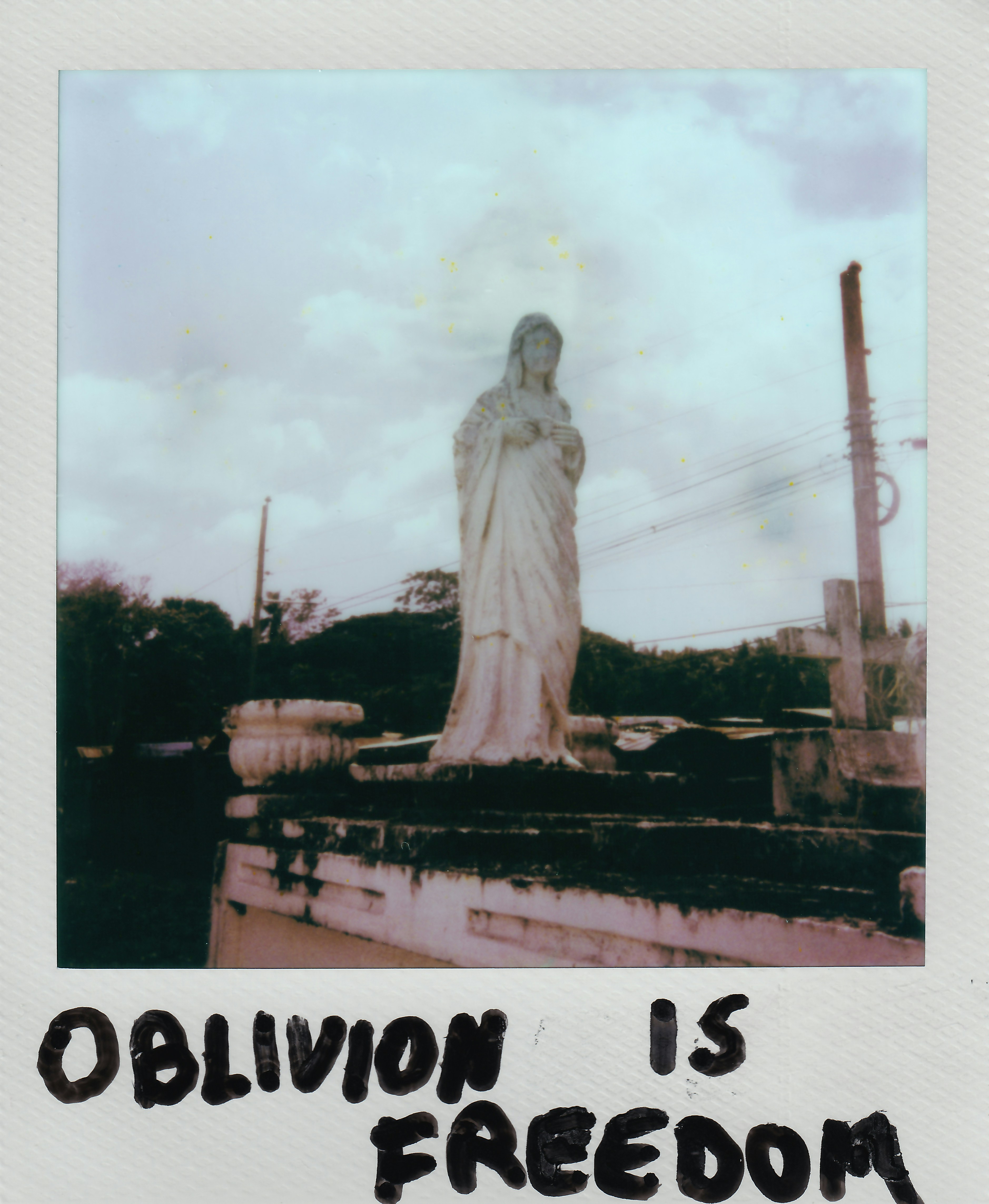 Old statue of a woman with "oblivion is freedom" text.