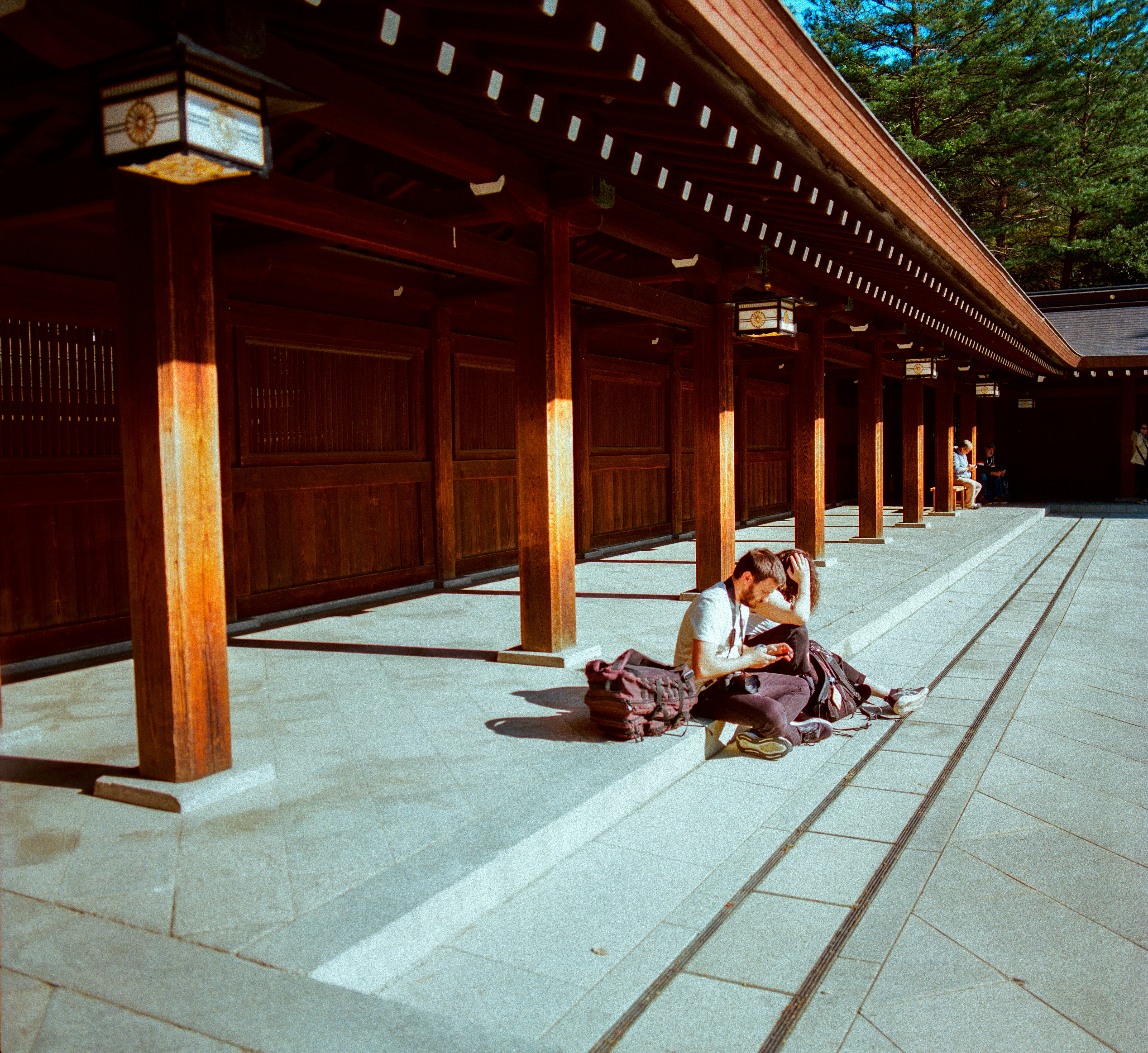 A person relaxing on steps of a traditional japanese temple