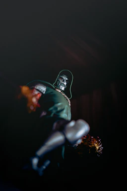 Dr. doom action figure in dark with fiery effects