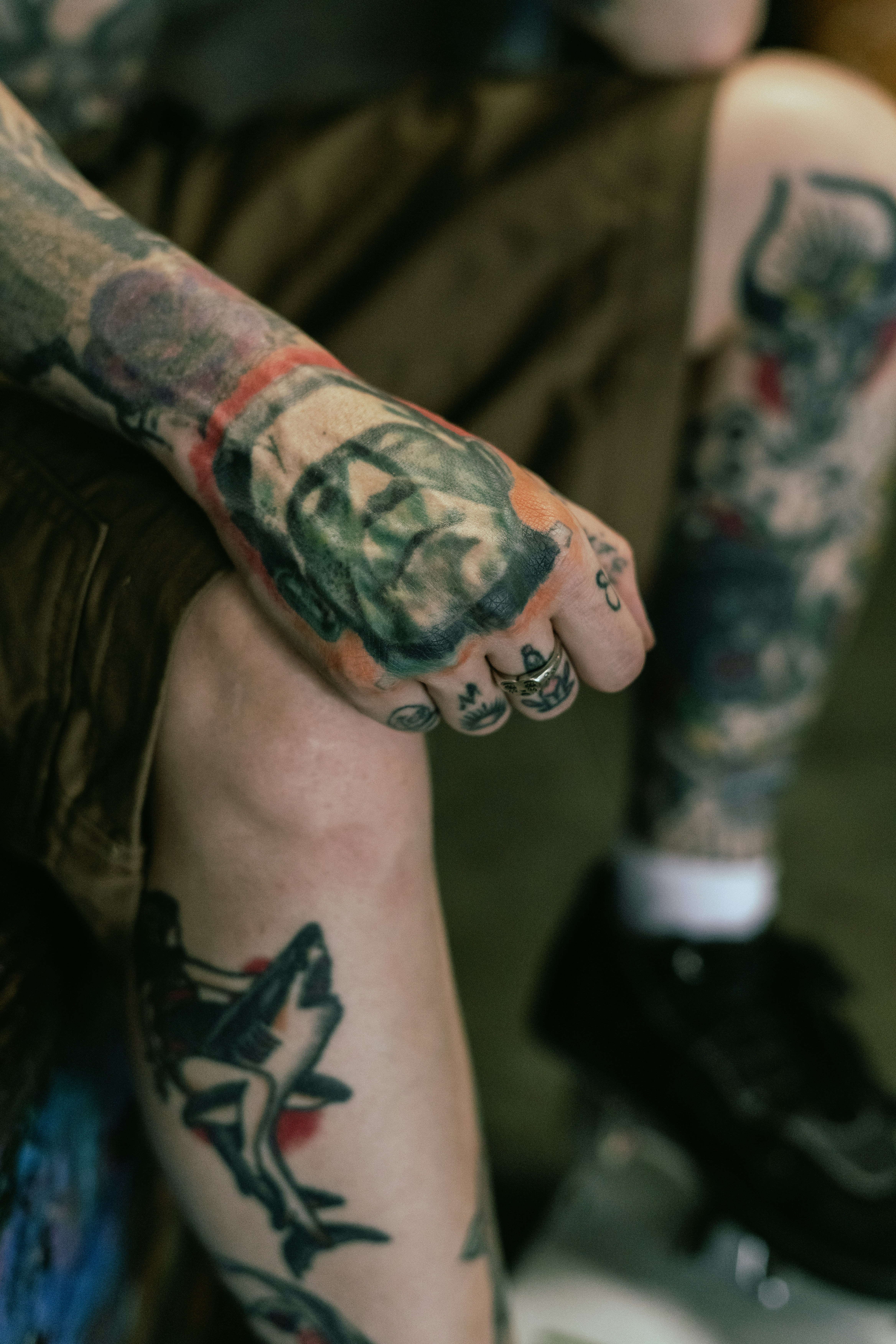 A person's legs and feet covered in intricate, colorful tattoos