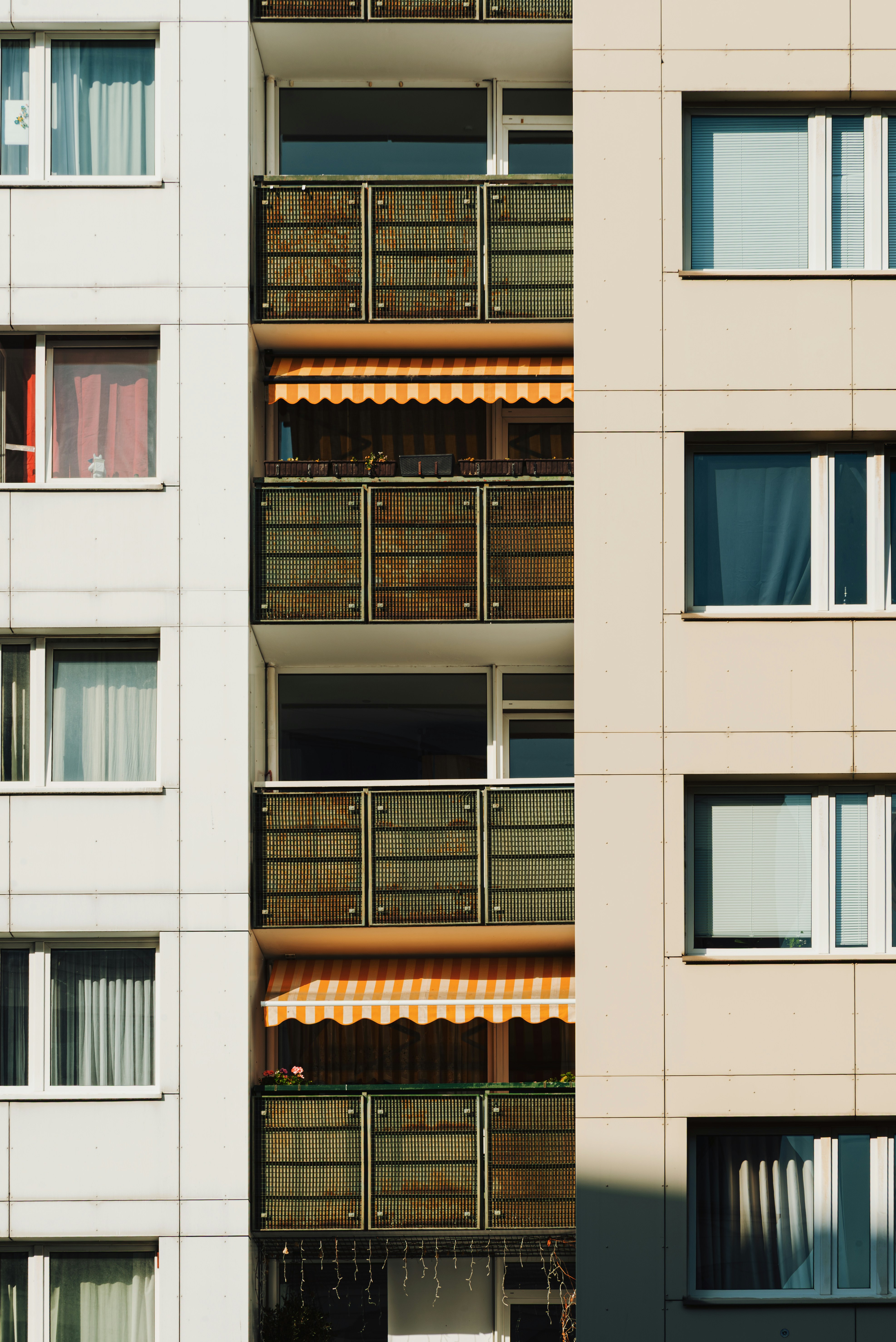 Berlin apartment building facade with balconies and awnings