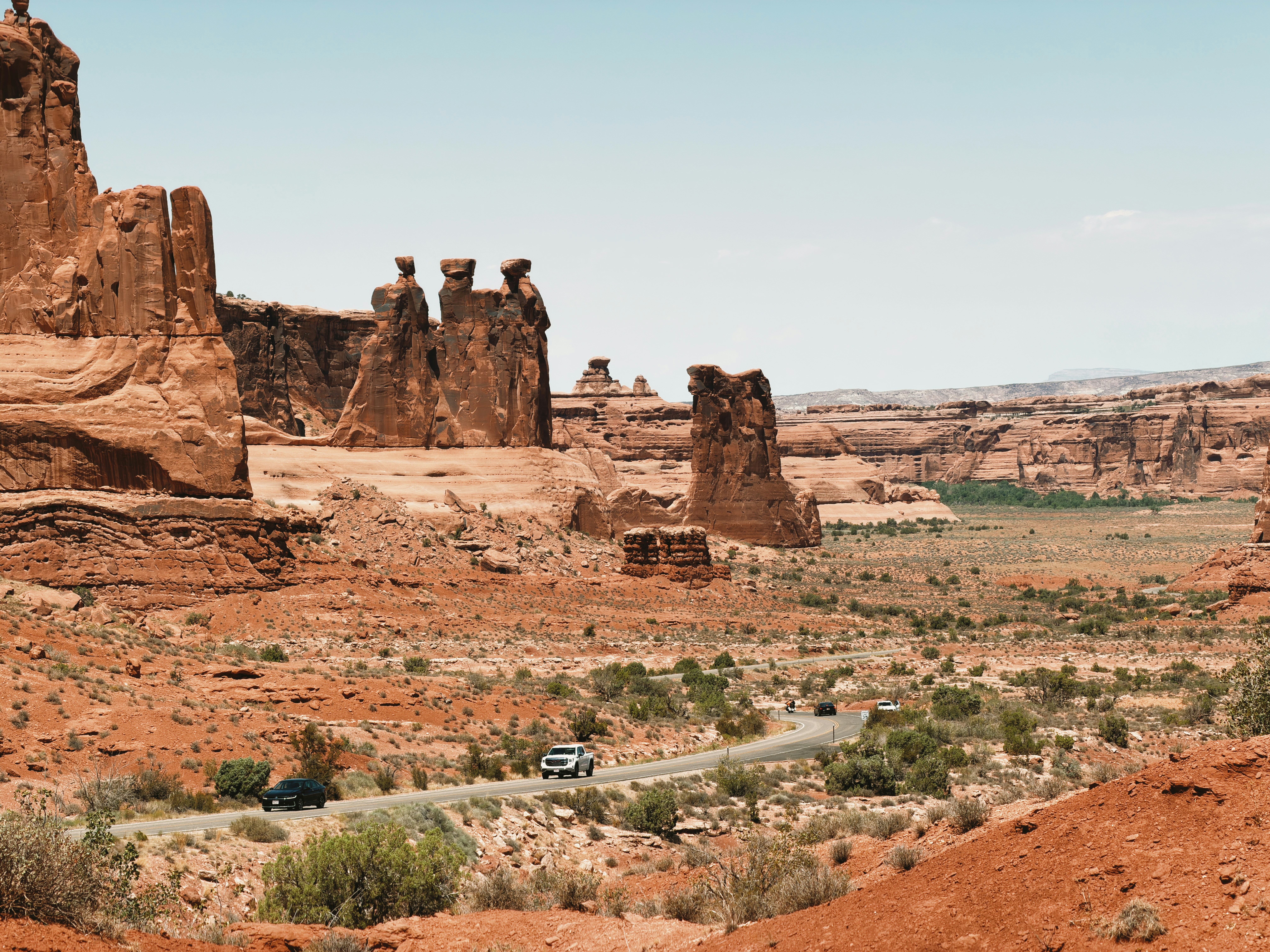 Desert landscape with red rock formations and a winding road