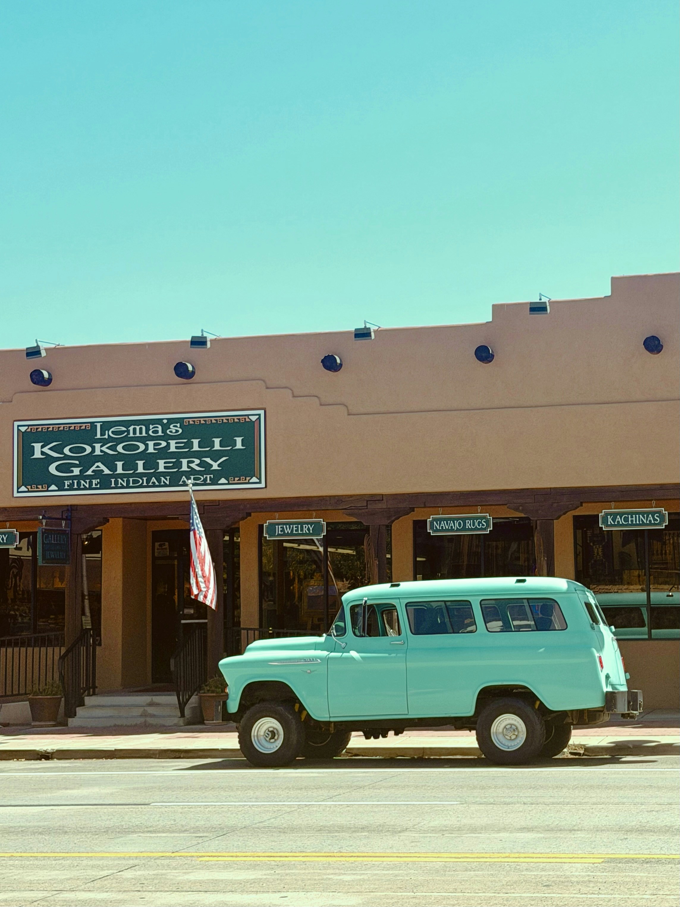 Vintage turquoise suv parked outside lema's kokopelli gallery