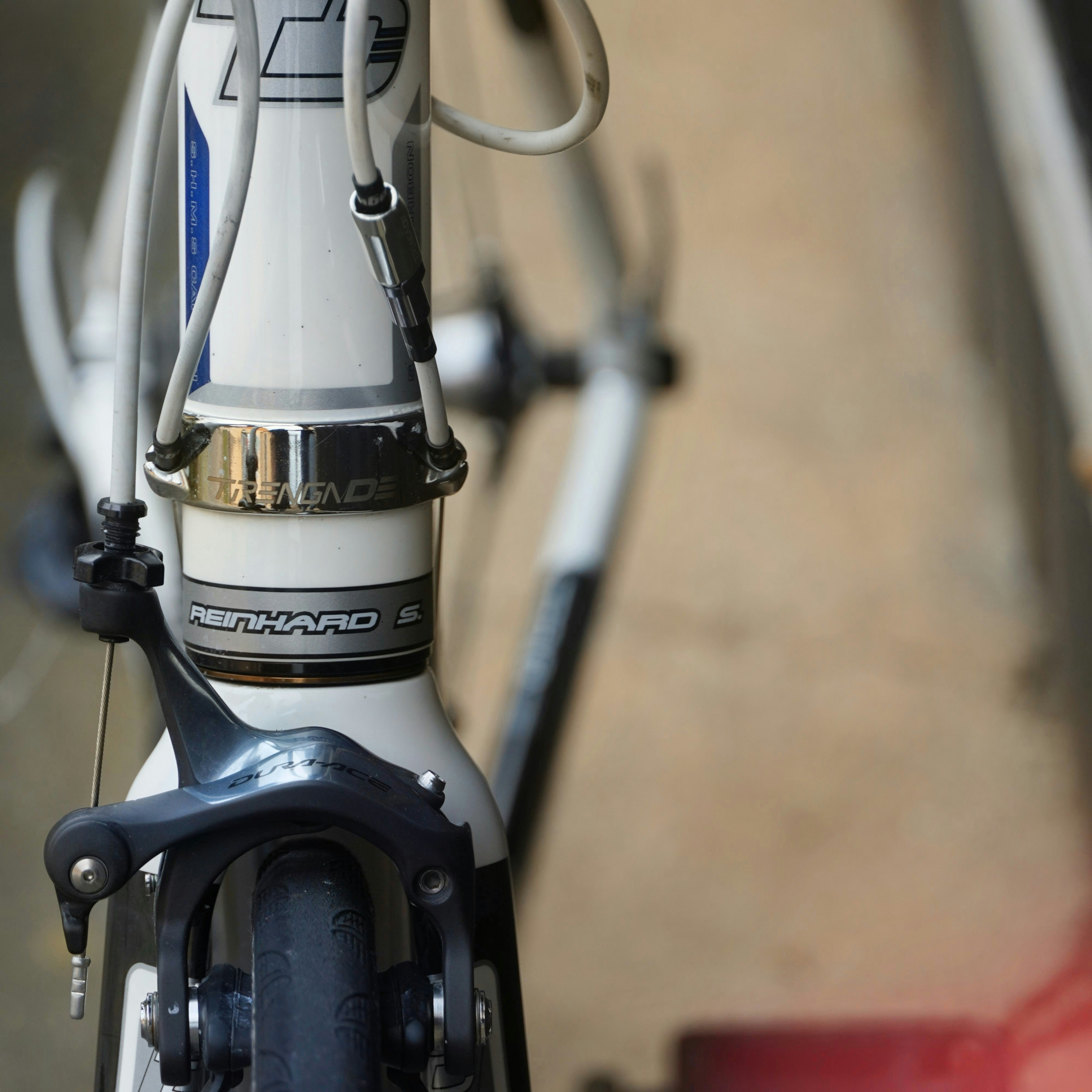 White road bicycle with front brake and handlebars visible