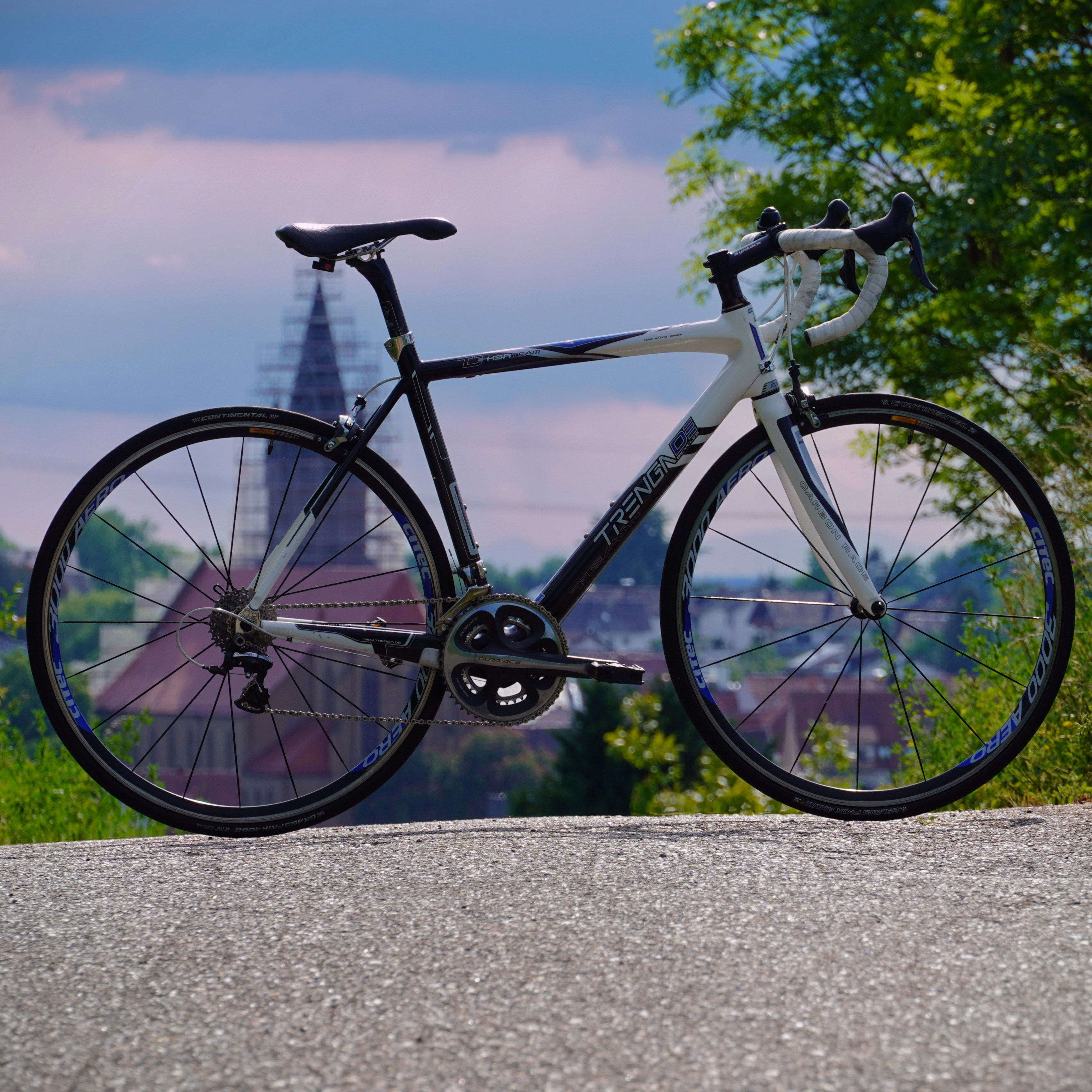 A black and white road bike on a paved path