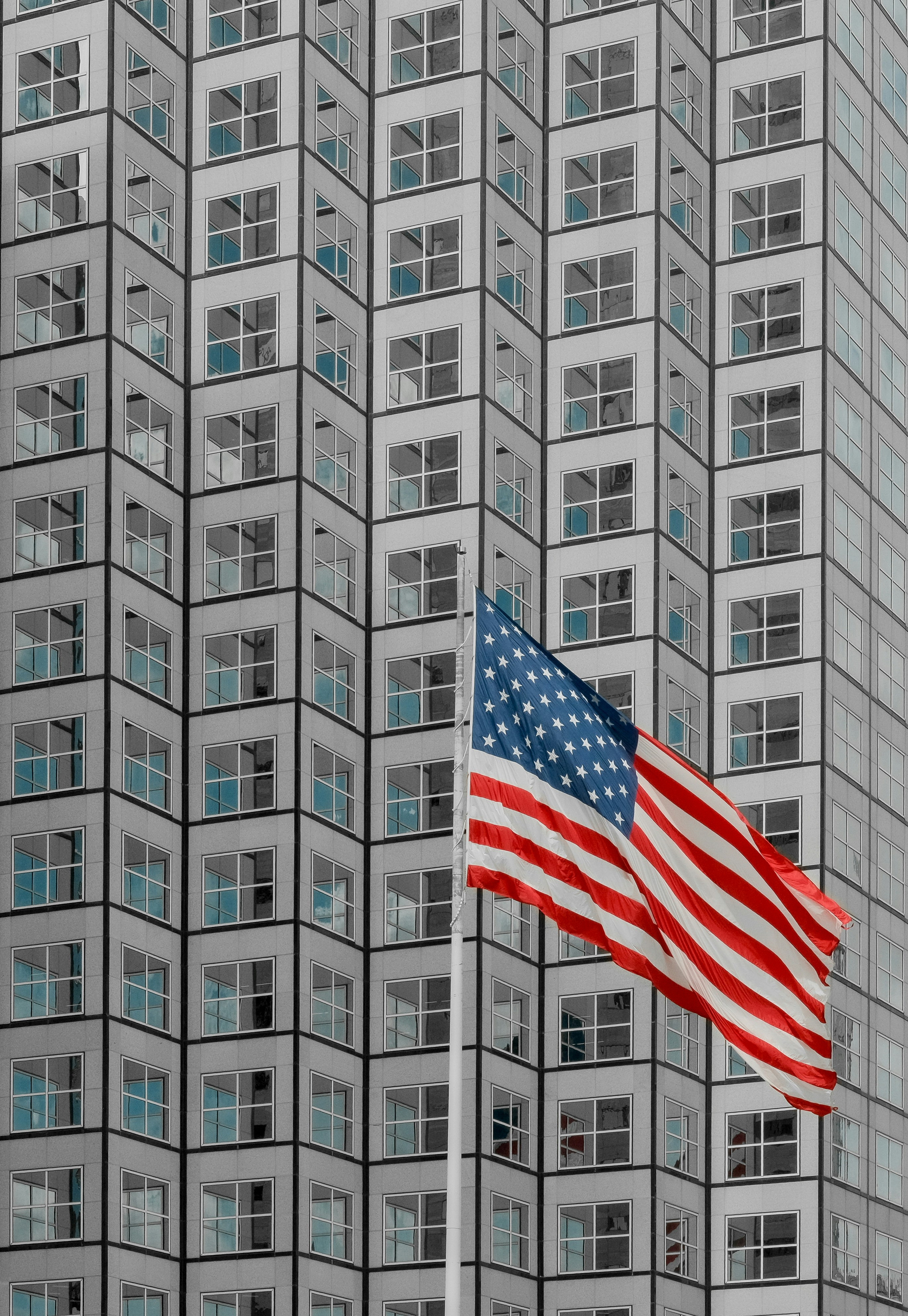 American flag flying before miami skyscraper