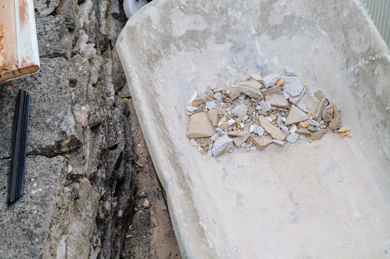 A wheelbarrow filled with construction debris on a work site