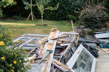 Window frames and wood debris in garden