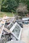 Discarded window frames and construction waste in yard
