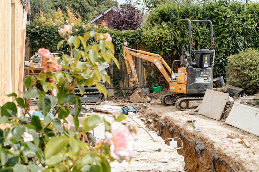 Mini excavator digging out ground in a garden ready for a new base