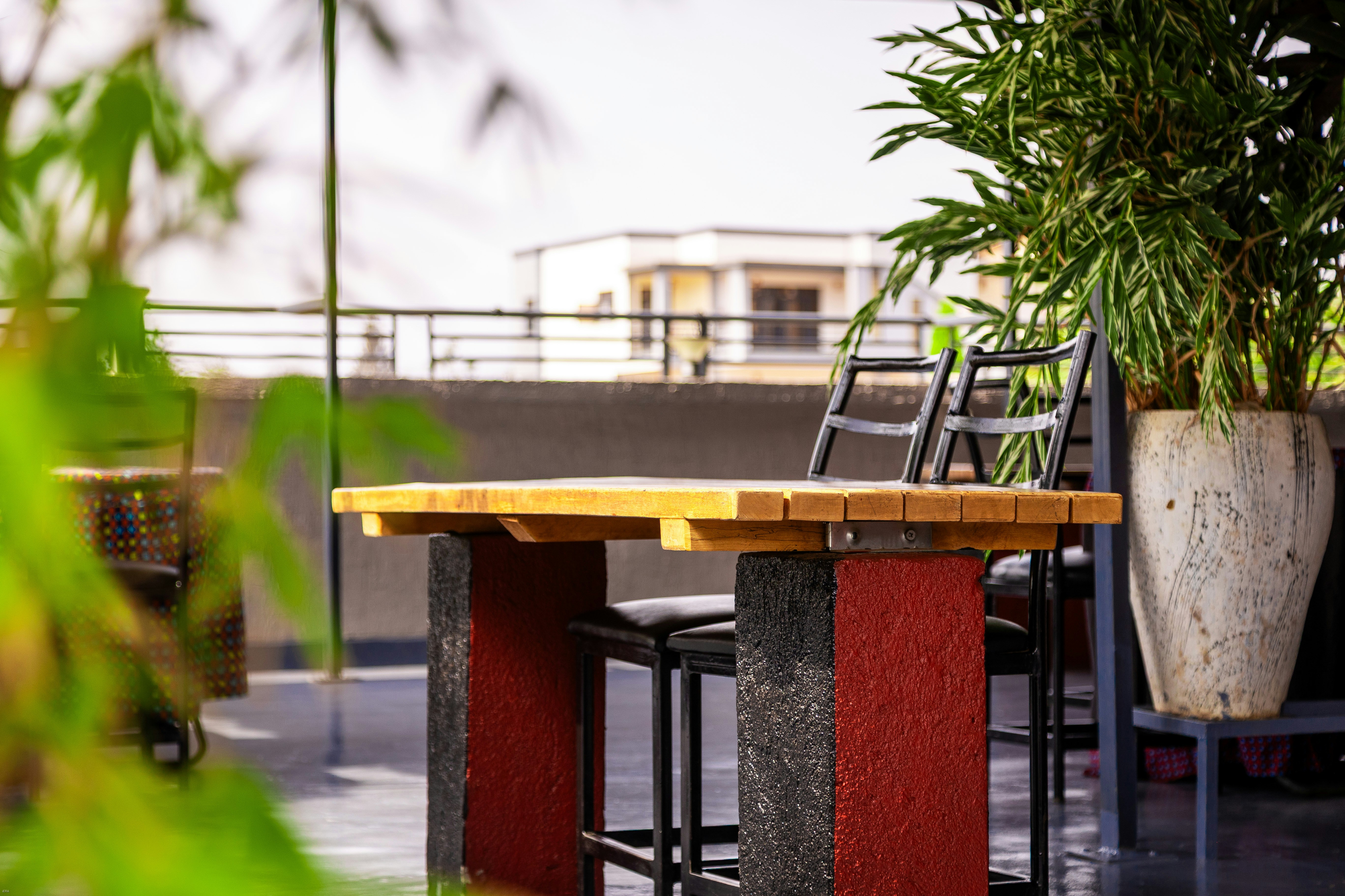 Outdoor patio with a wooden high table and plants