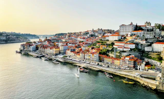 Vibrant city with colorful buildings lining a wide river