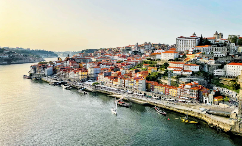 Vibrant city with colorful buildings lining a wide river