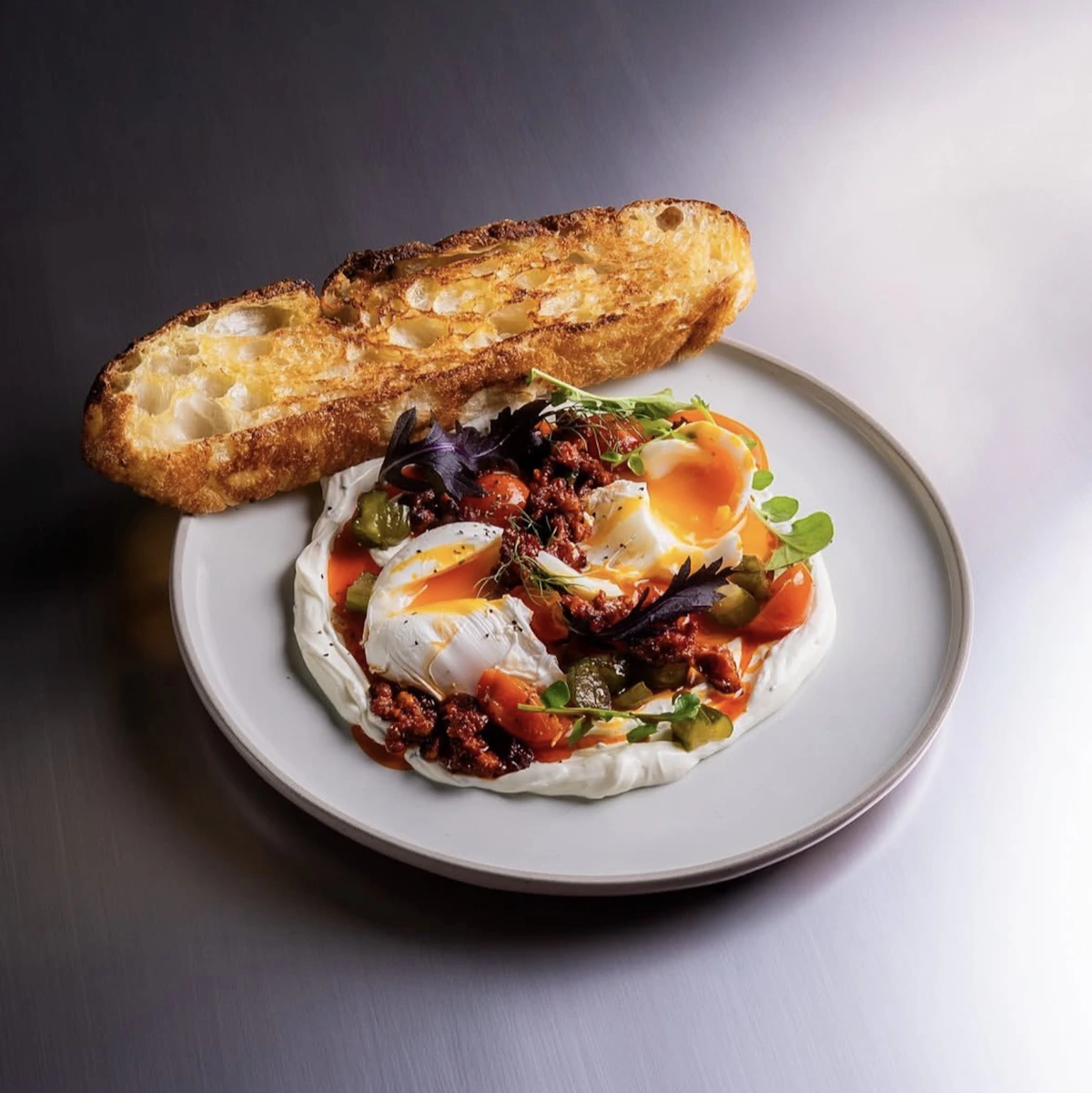 Real plated high-protein meal with eggs, vegetables, yogurt, and toast