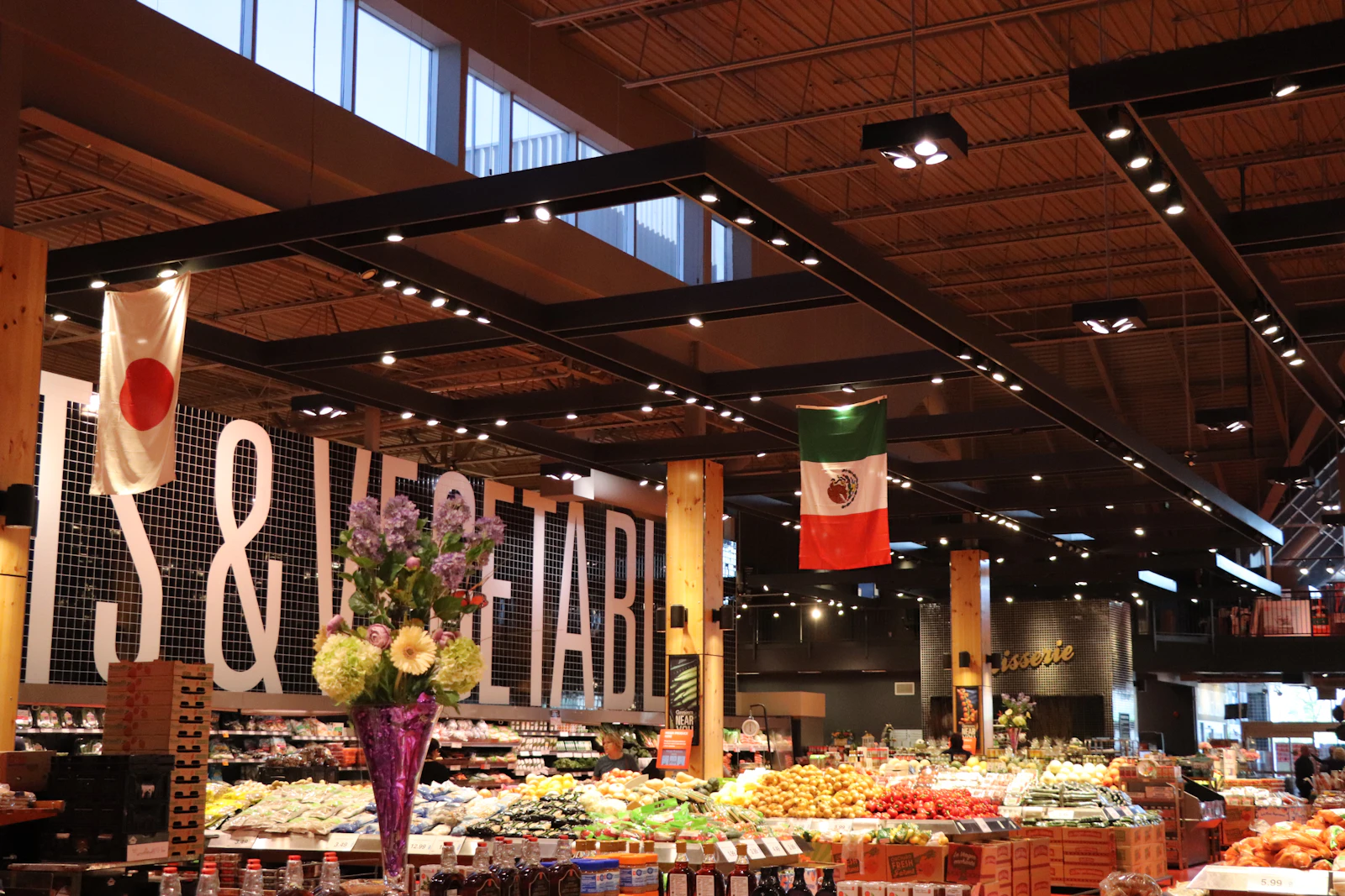 Fresh fruit and vegetables on display in a brightly lit grocery store.