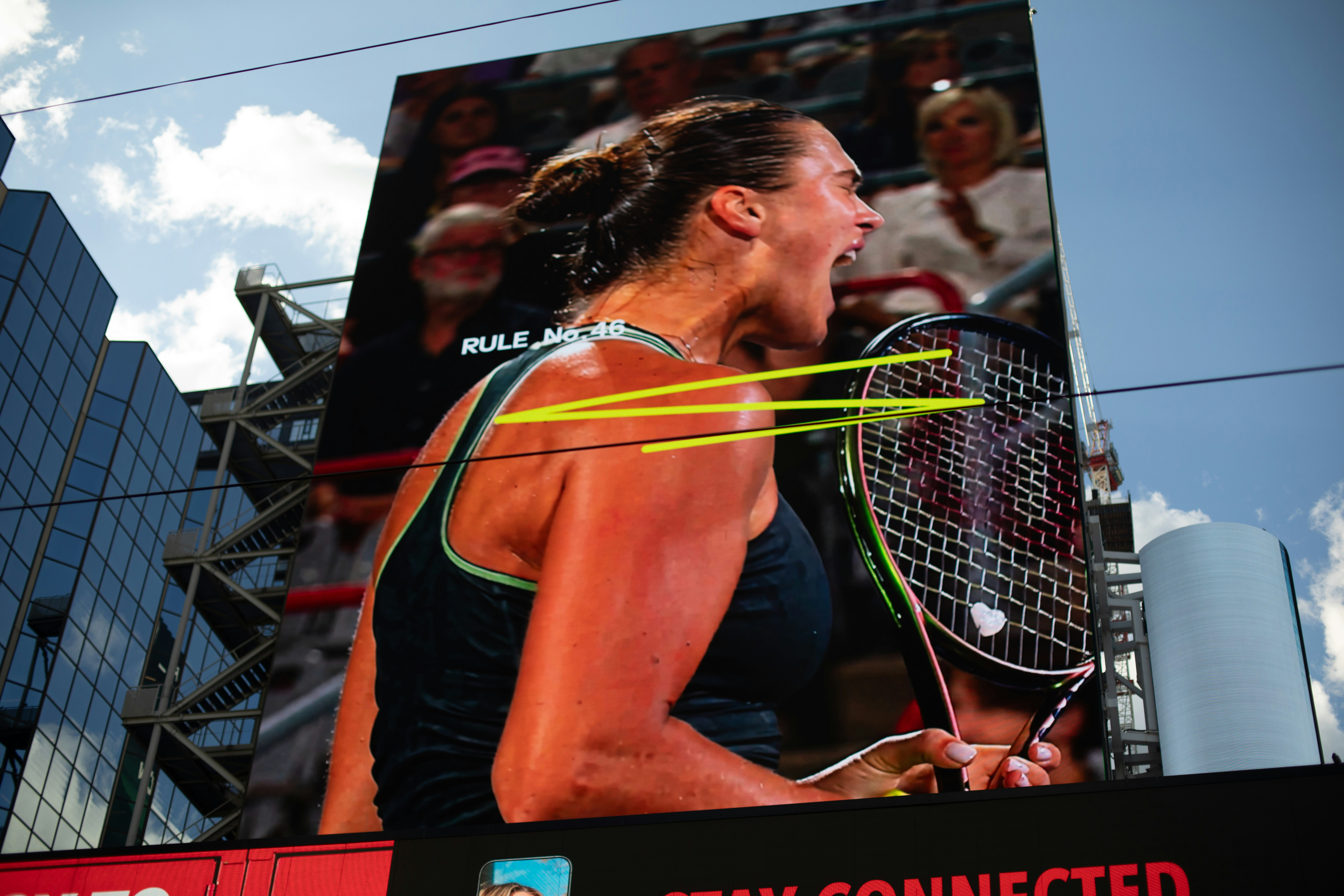 Digital billboard displays a screaming female tennis player with racket