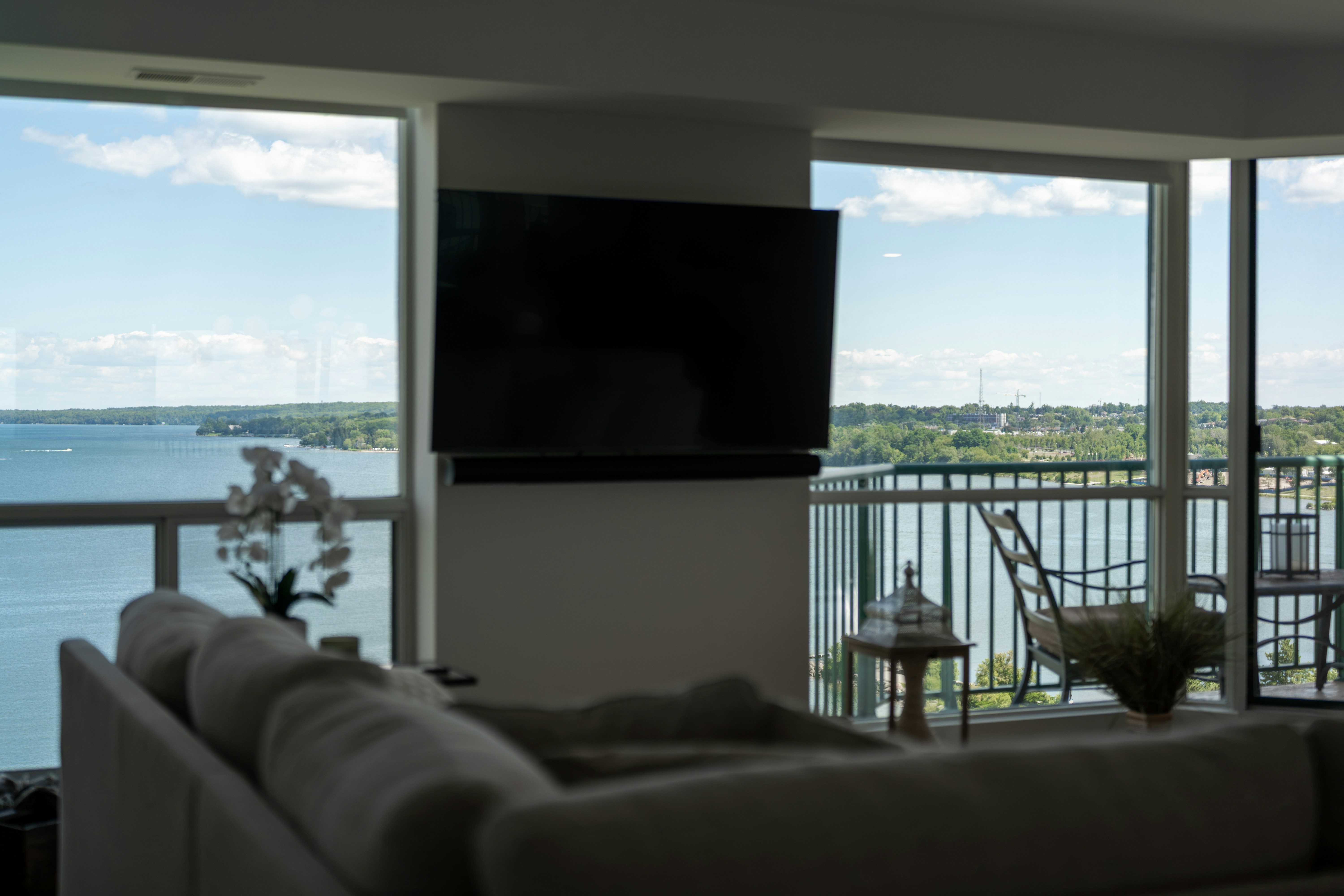 Condo living room with large windows and a water view