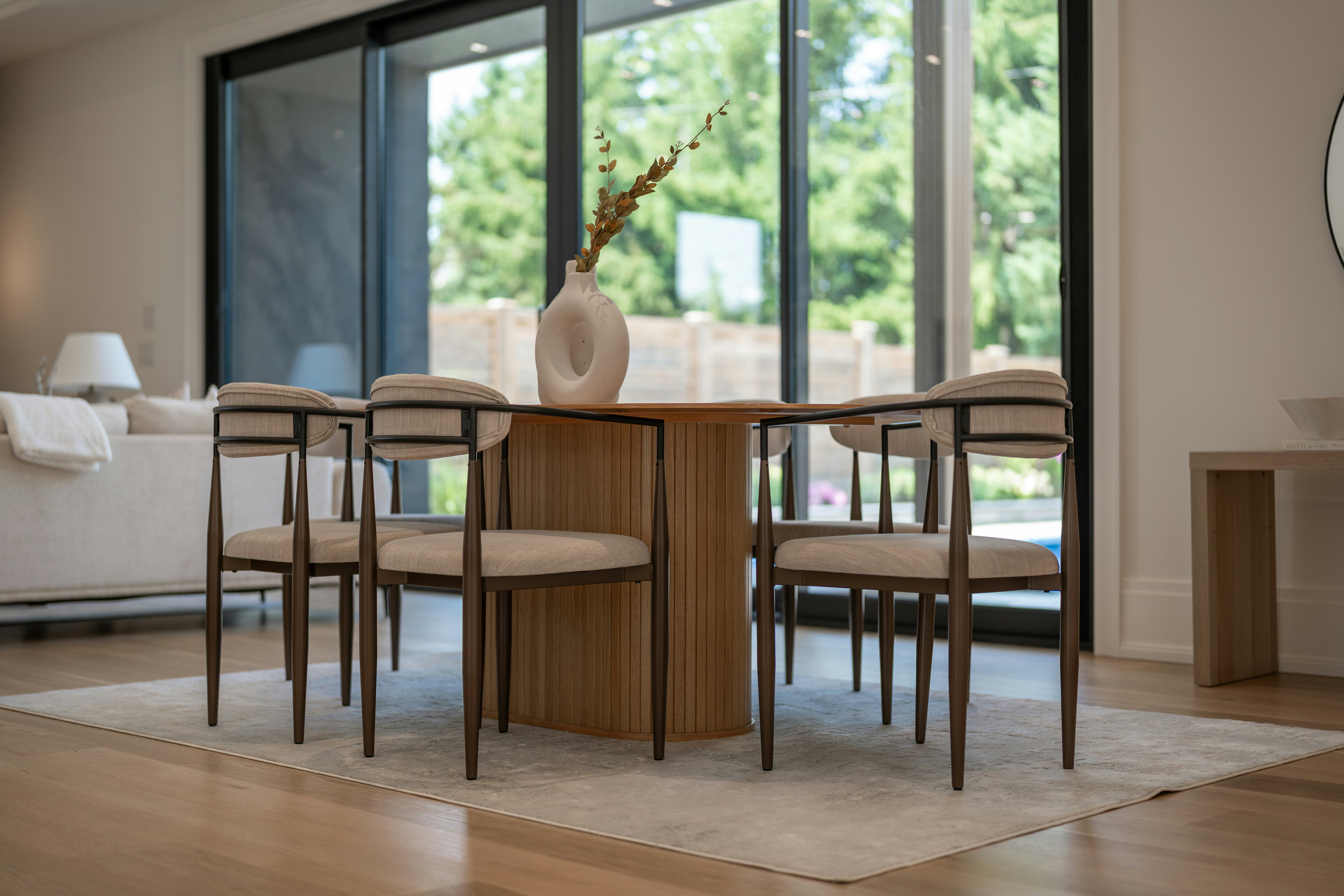 Stylish dining area with wooden table and chairs.
