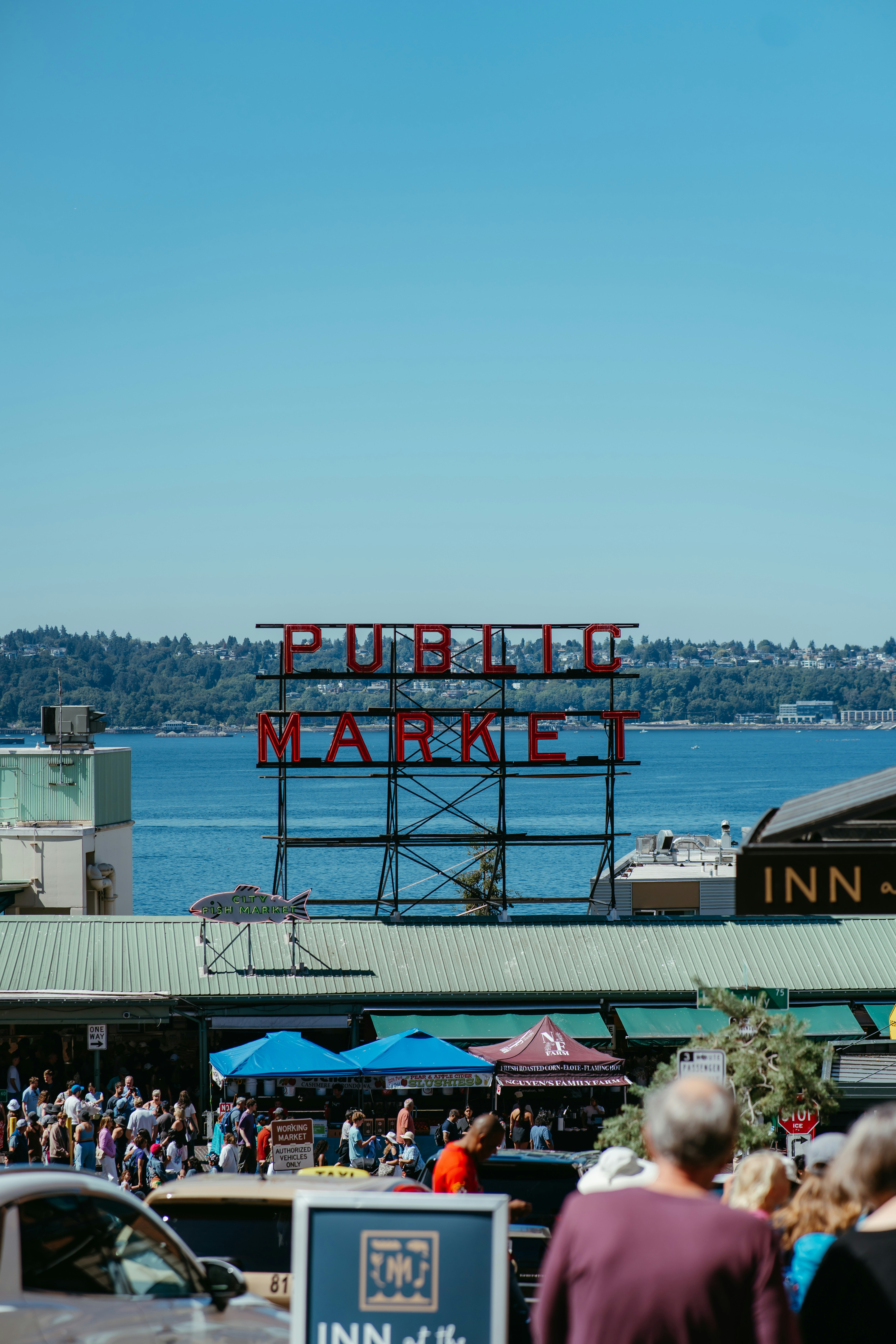 Iconic public market sign overlooking a bustling waterfront scene