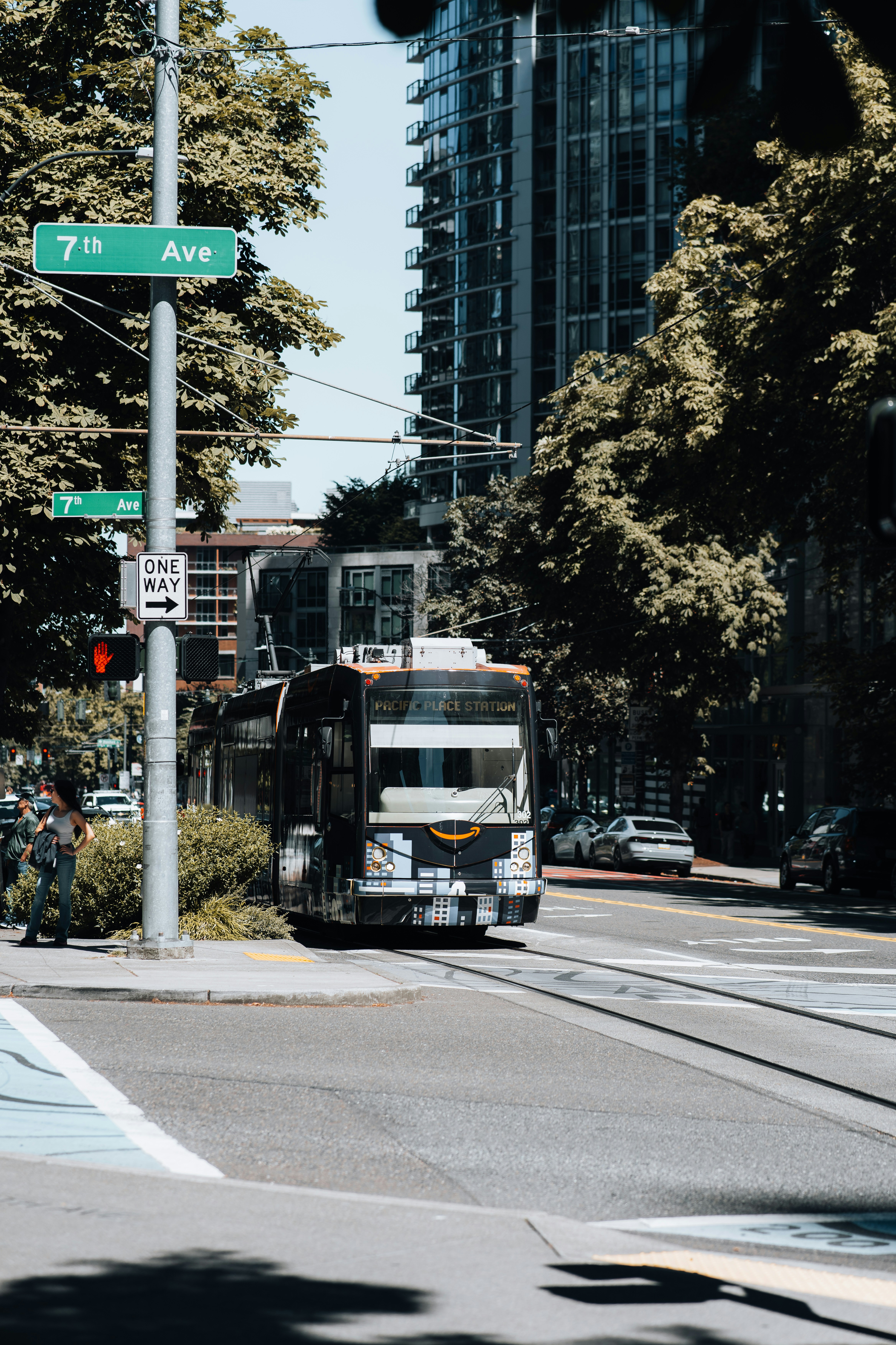 A city bus travels down 7th avenue