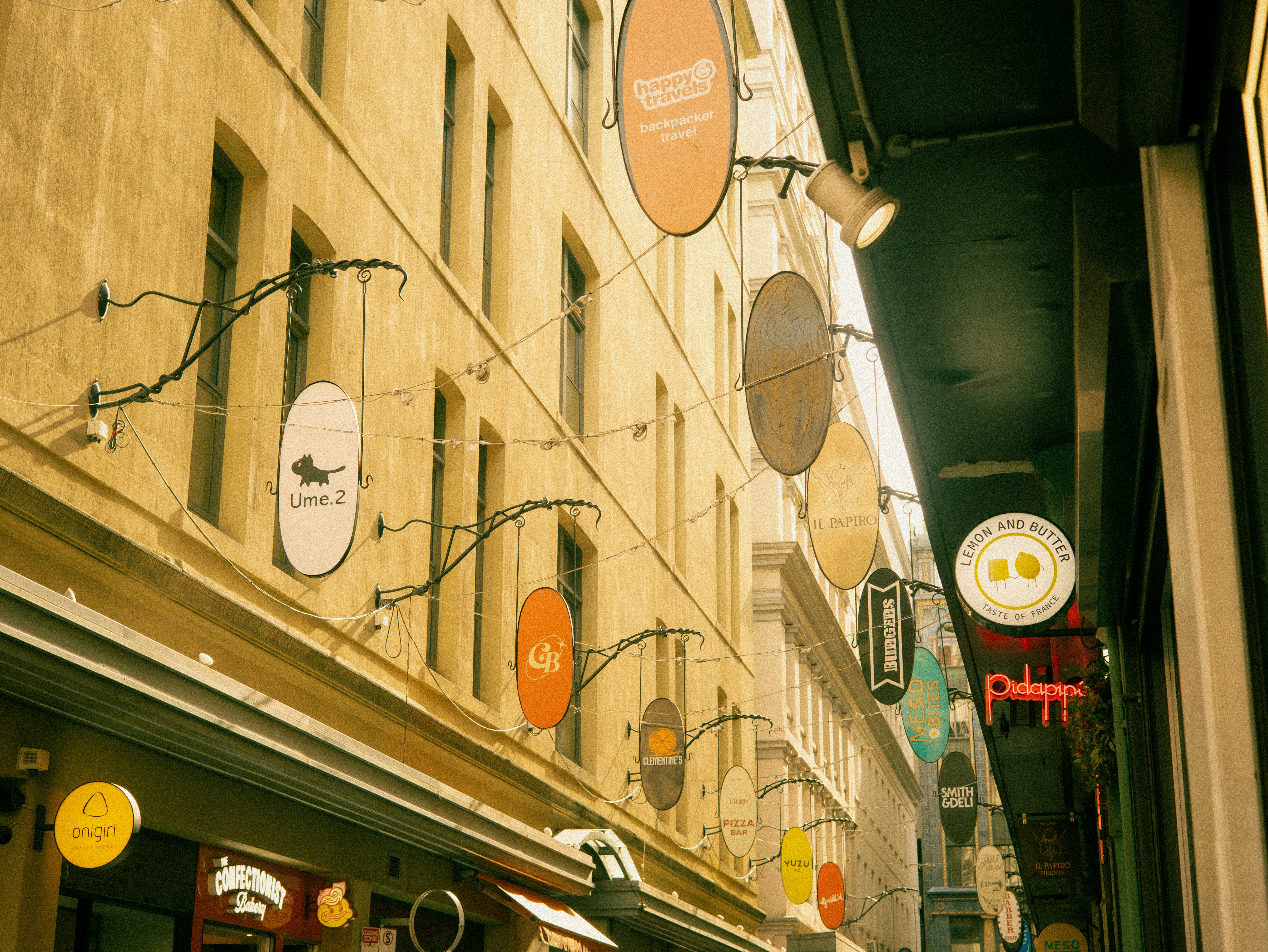Narrow laneway with many hanging shop signs