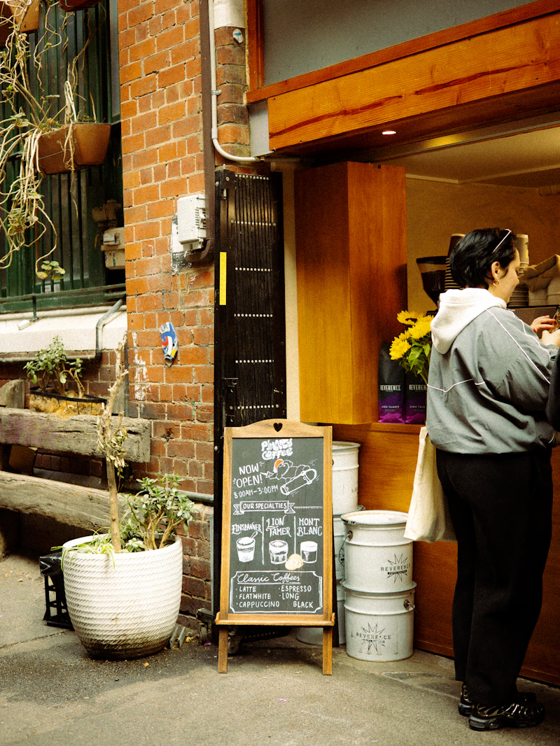 A customer ordering at a laneway café counter