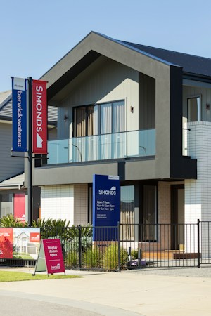 Modern house with real estate signs out front, like the homes Las Vegas buyers are pricing at 7.4 percent mortgage rates