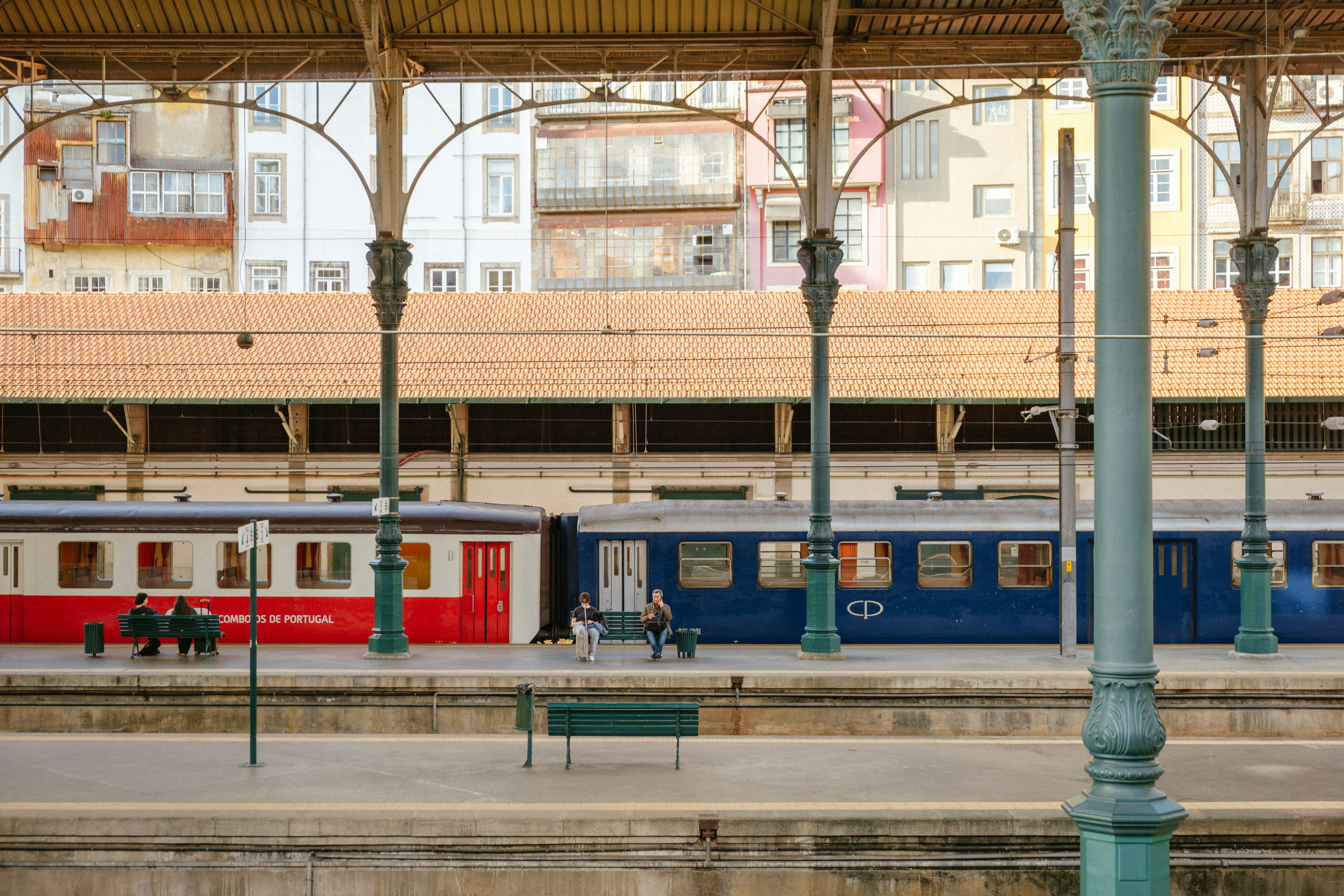 Red and blue train carriages at station platform