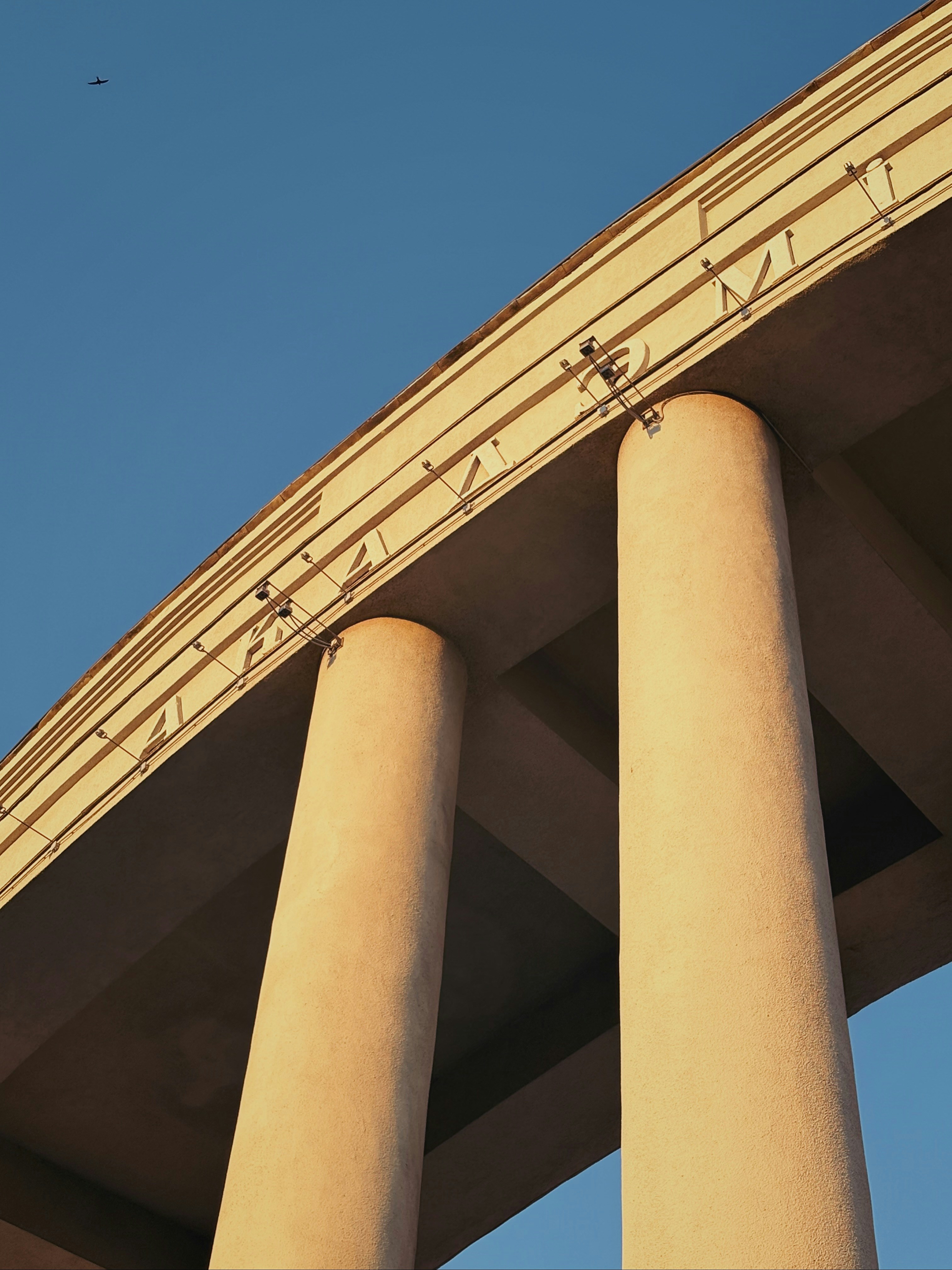Concrete bridge pillars against a clear blue sky