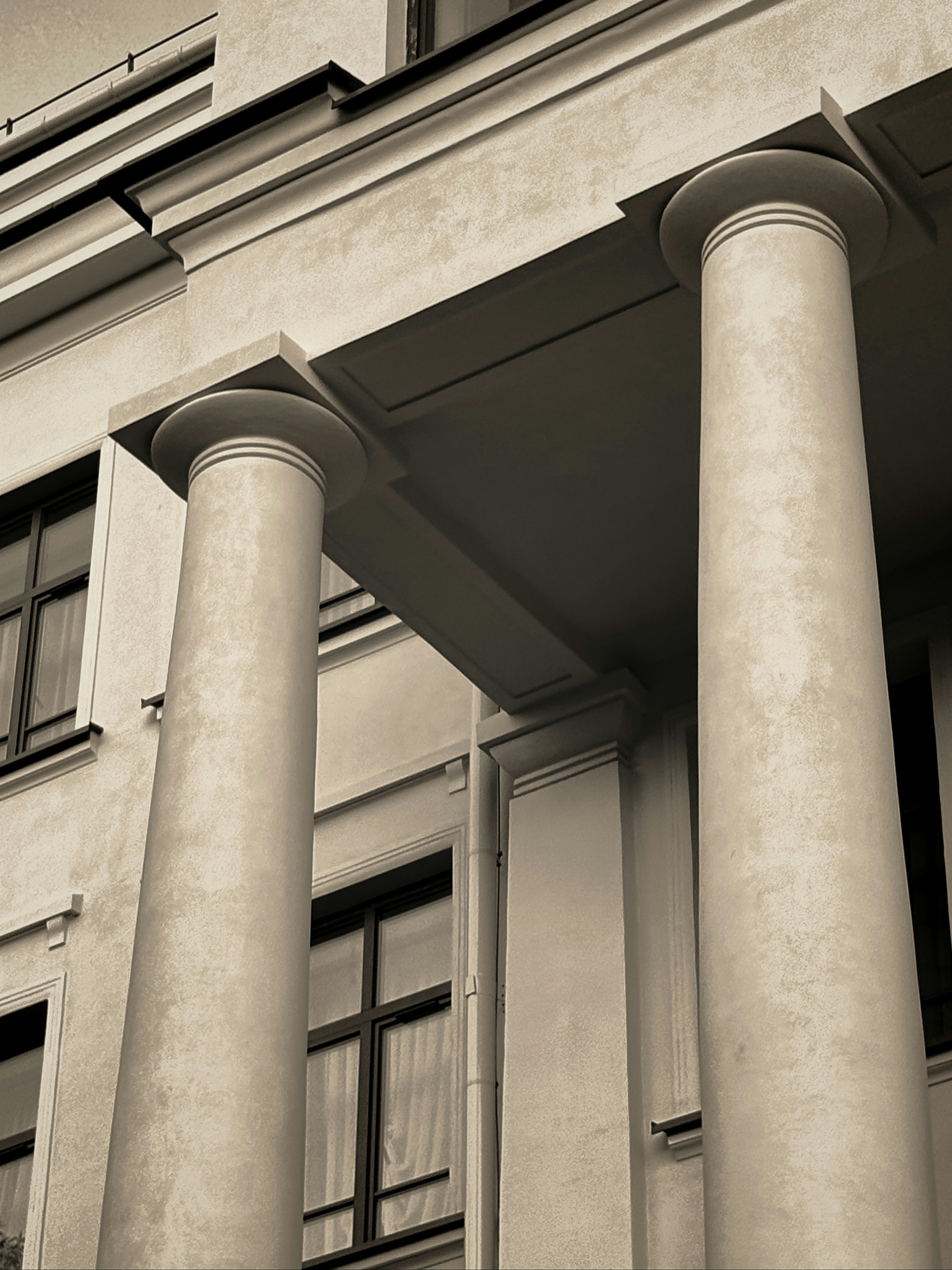 Two classical architectural columns supporting a building facade
